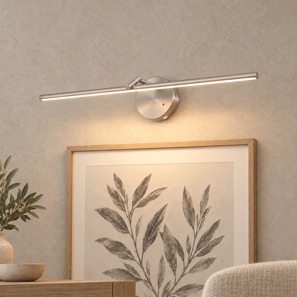 Nolesira nickel rechargeable wall sconce lighting a framed print on a dining room wall #color_nickel