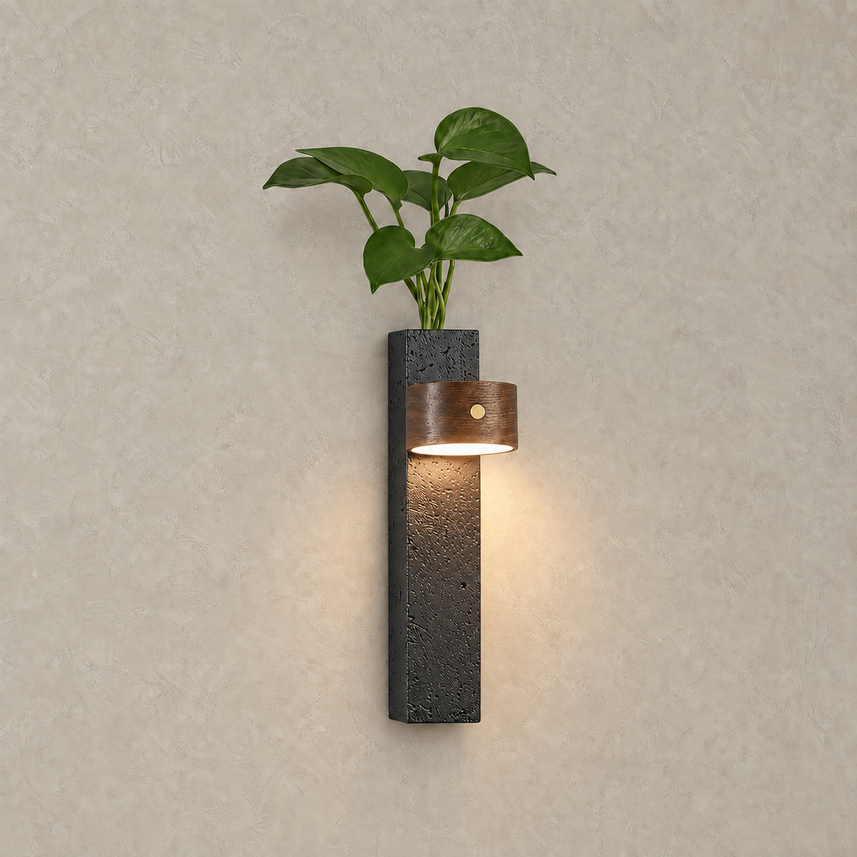 Nuvelira LED wall sconce in dark walnut & black travertine with a warm downward glow over the stone body