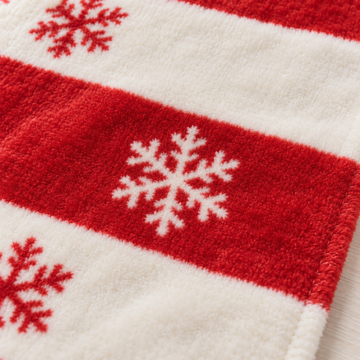 Olmarin striped snowflake throw blanket in red and white with a close view of the printed flannel