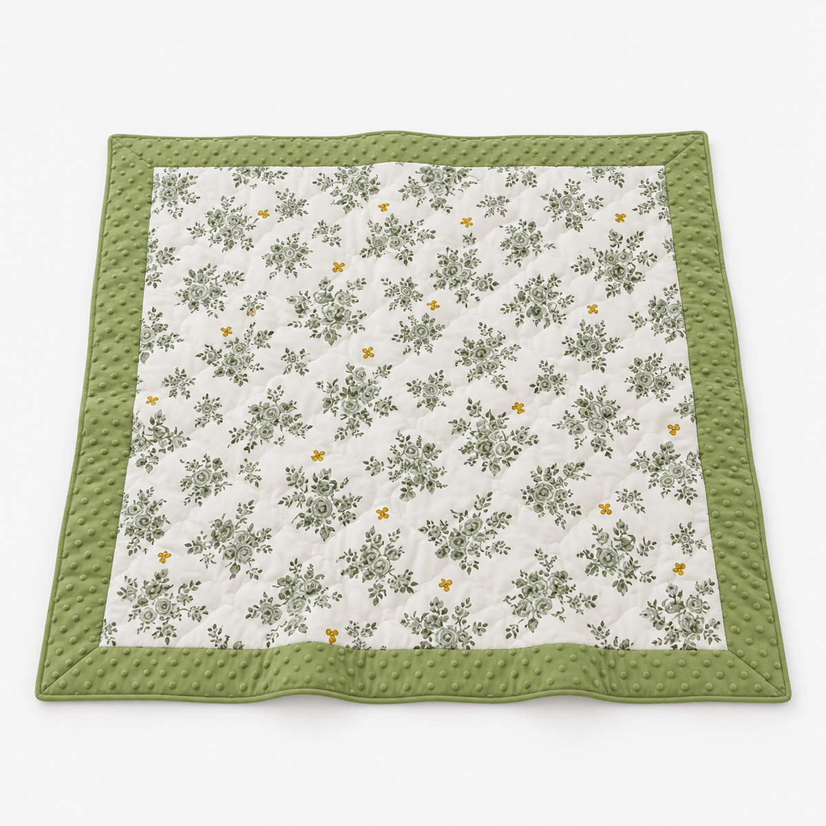 Olmesa floral cotton summer quilt in white and green, whole quilt laid open with green bouquets and a broad border