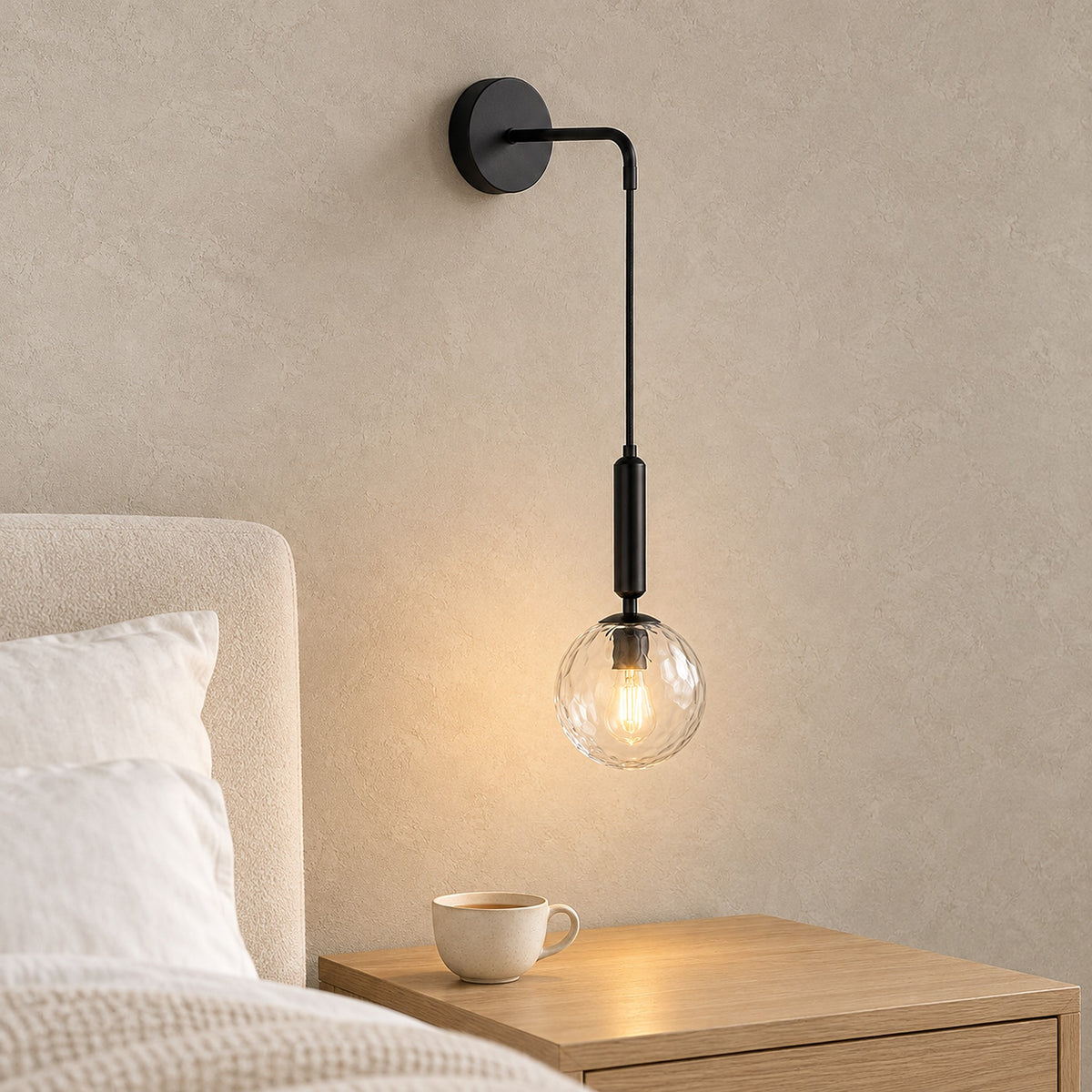 Orlamen black bedside wall light glowing beside the bed, leaving the nightstand clear for tea