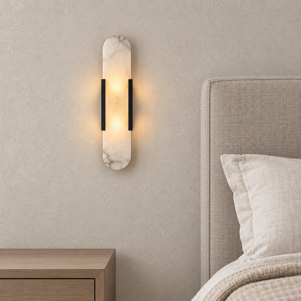 Oselira black bedside wall light glowing above a nightstand beside a bed in a guest sleeping alcove