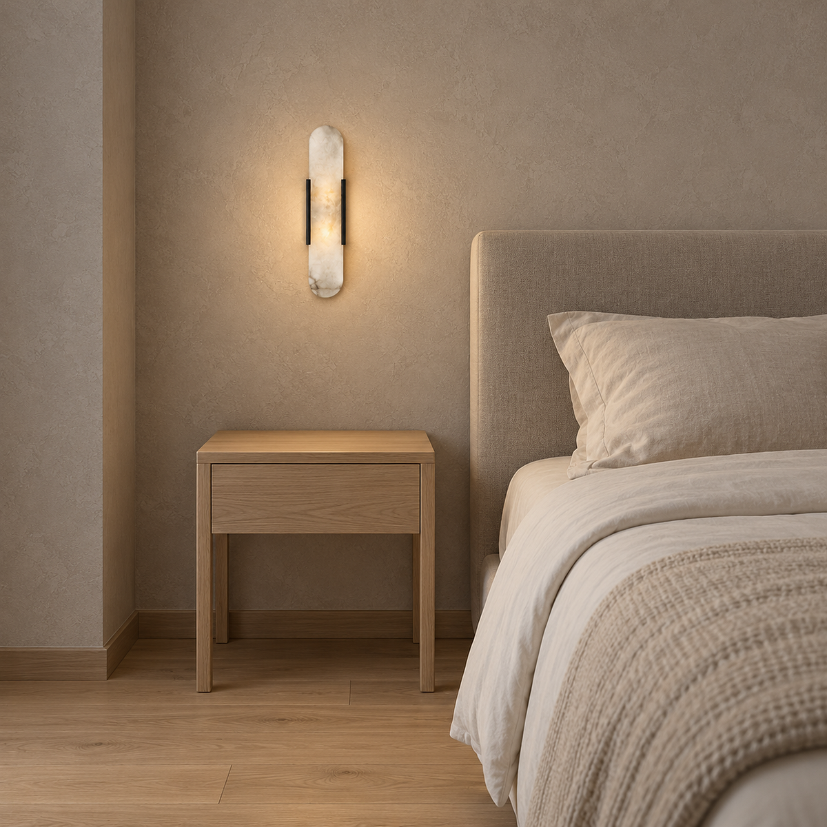 Oselira pale gray veined wall light fitting with black side bands glowing above a bedside table beside a bed