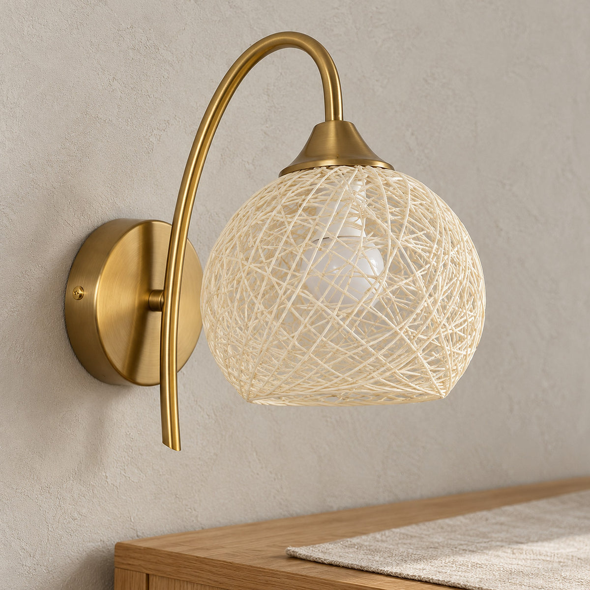 Remilvo gold wall lamp close up showing the loose weave of its fabric shade