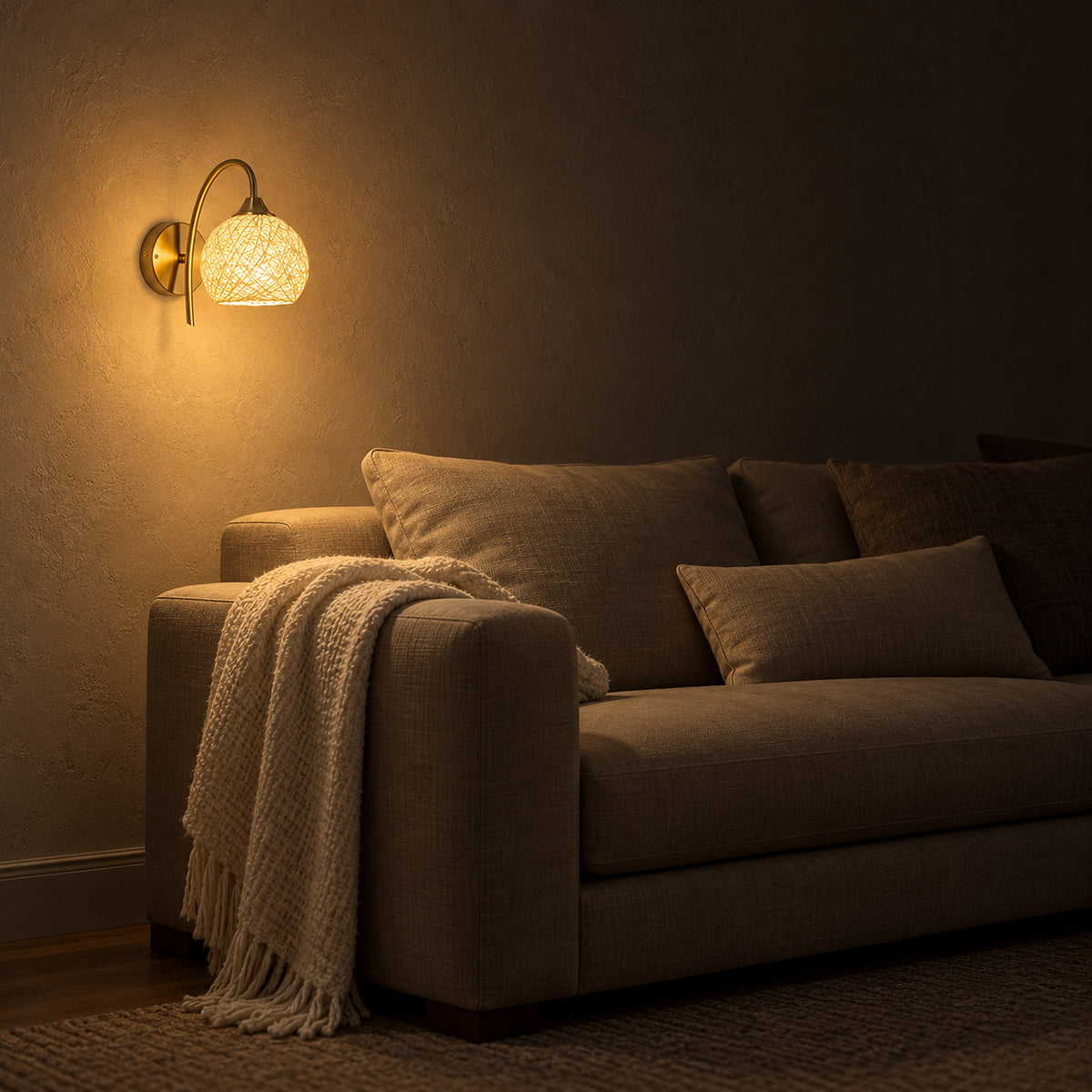 Remilvo gold wall lamp glowing low beside a sofa in a living room at night