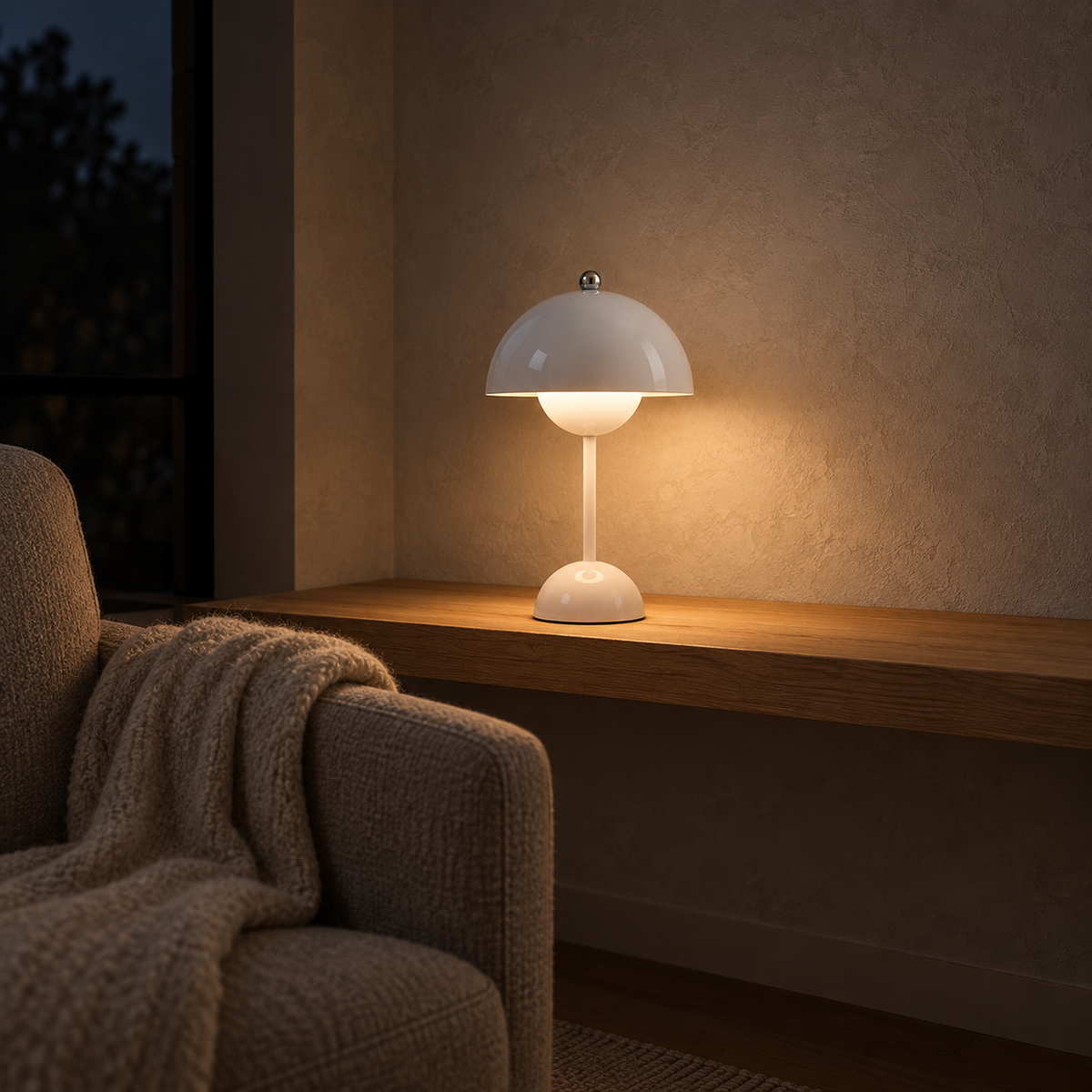 Retomira white bedside lamp casting a small pool of evening light in a library