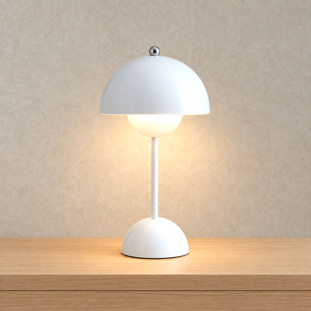 Retomira white table lamp lit softly beneath its broad domed shade