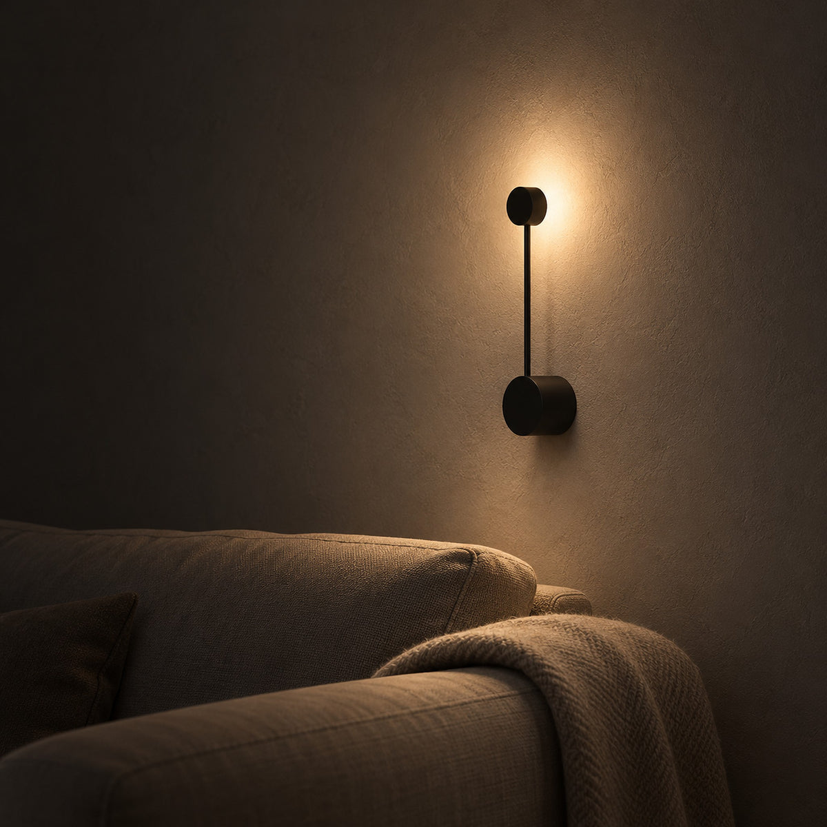 Rilameo black wall sconce with an evening accent glow beside a living room sofa