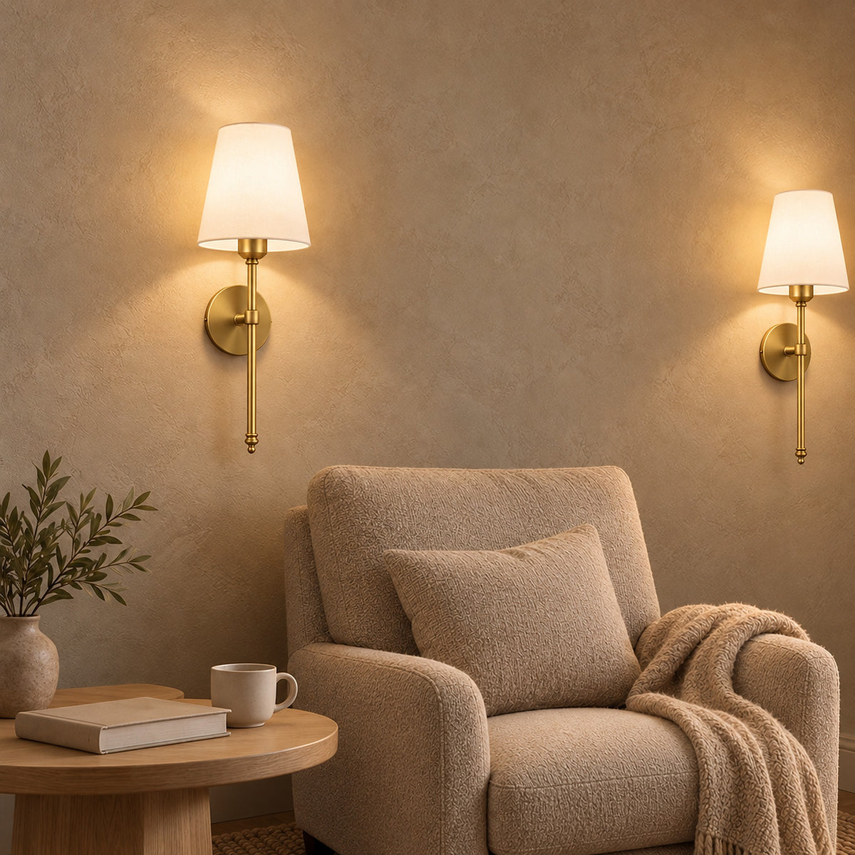 Rimavio gold battery operated wall sconce pair lit behind a reading chair #color_gold
