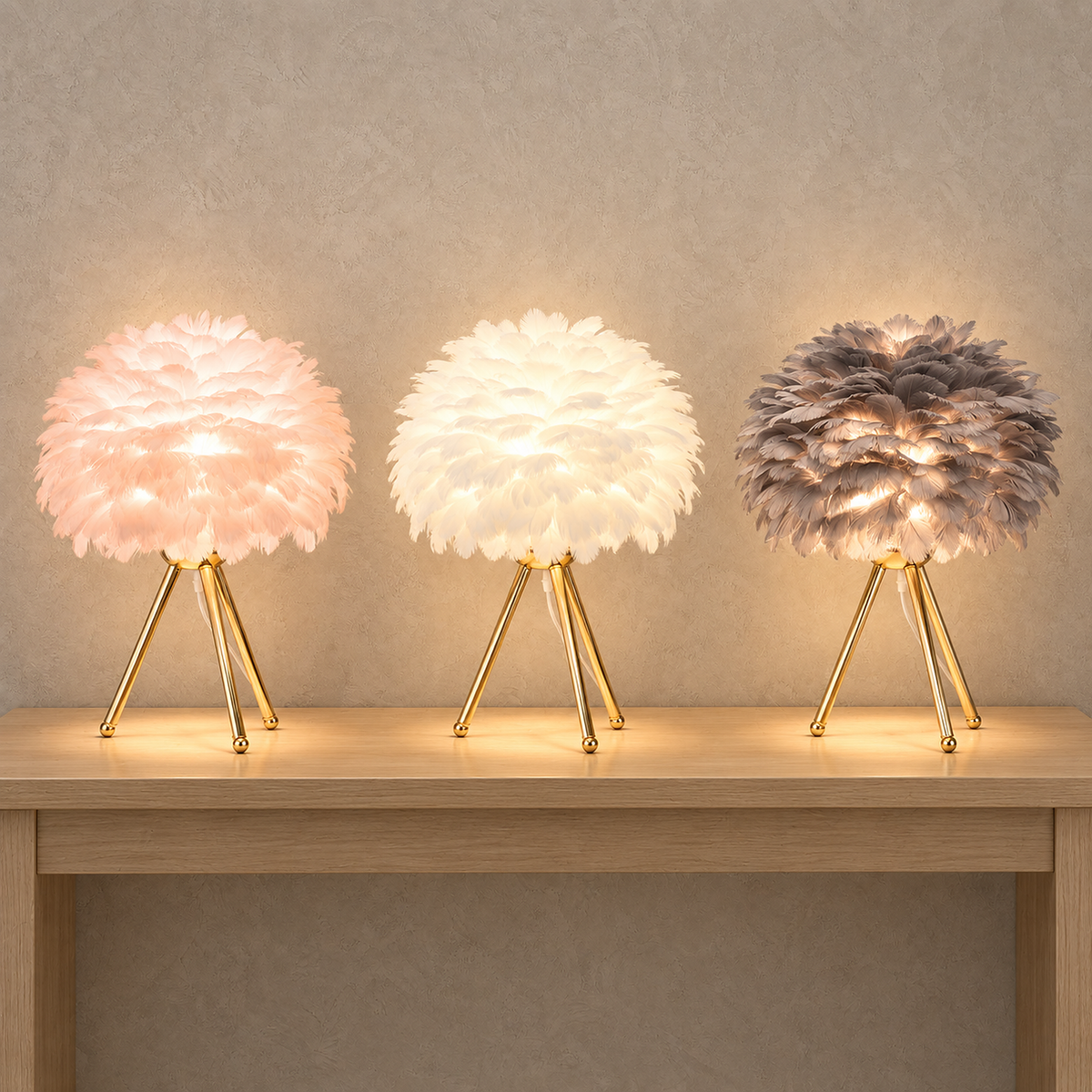 Rimolen feather table lamp in light pink gold, white gold and gray gold, all three lit together