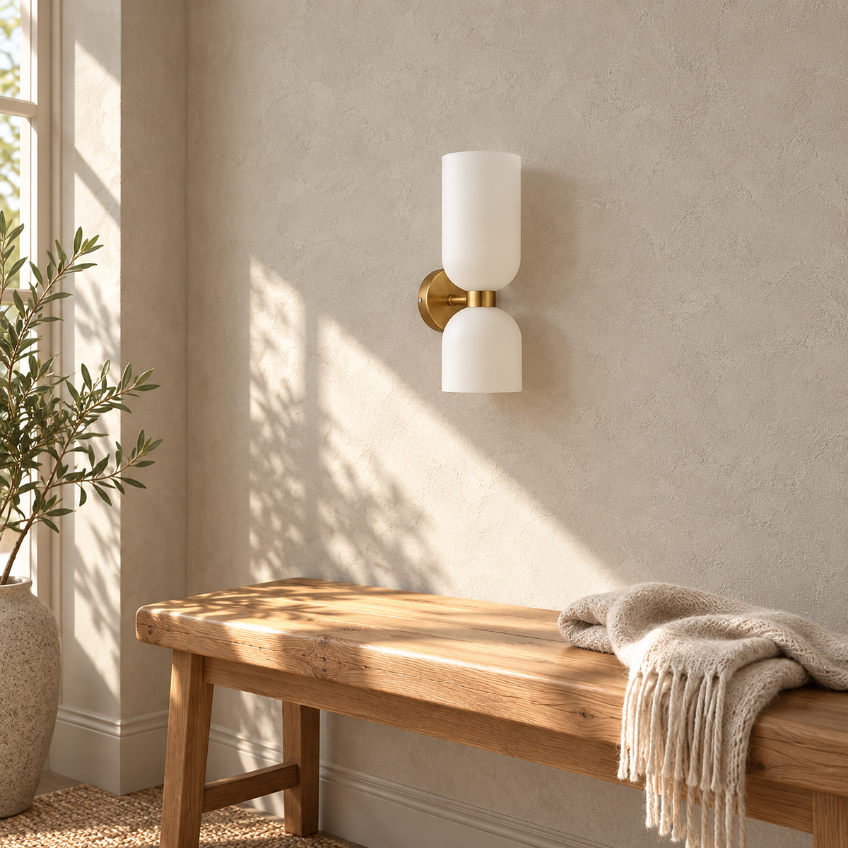 Riselona gold and opal glass wall sconce switched off above a sunny entryway bench