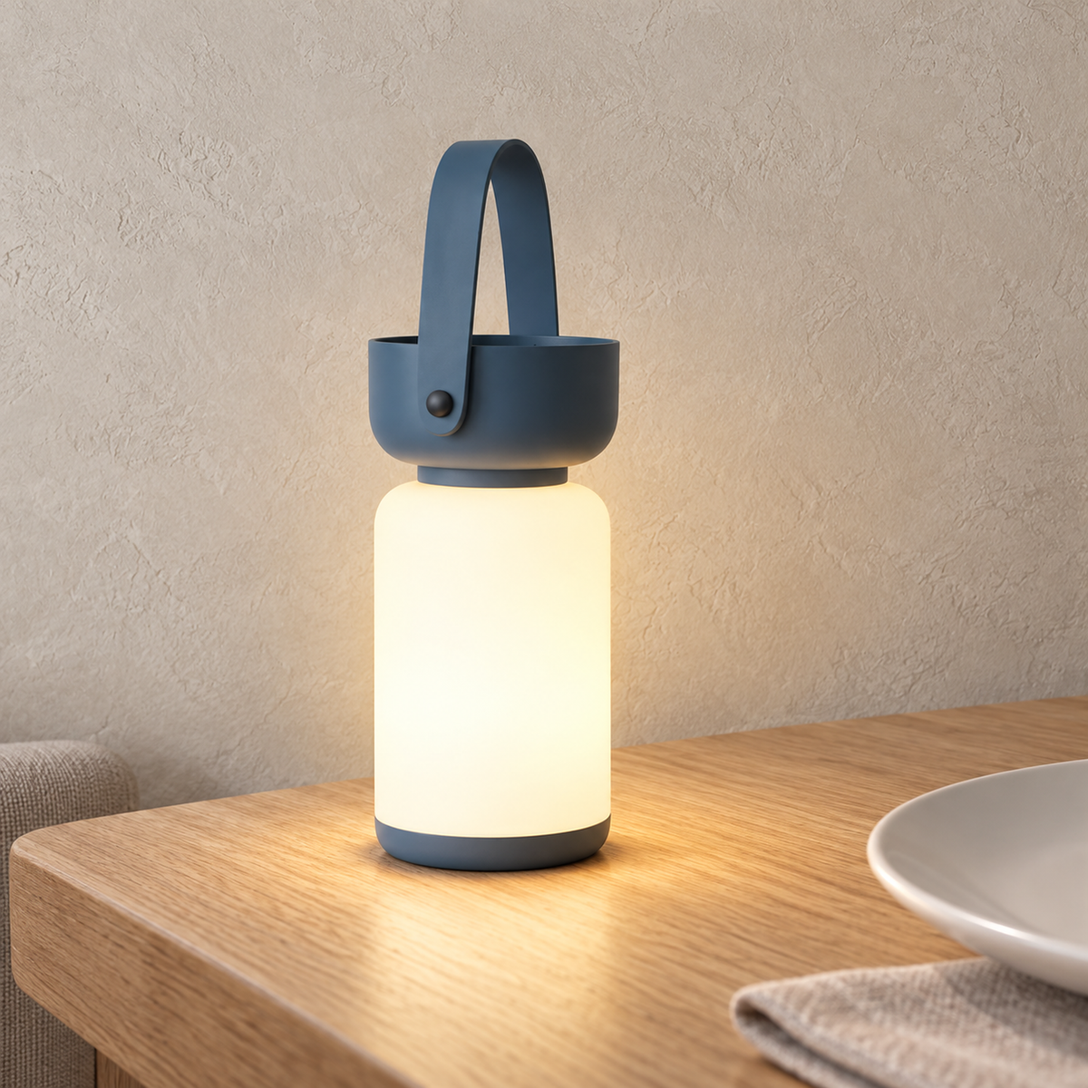 Ronalise blue table lamp glowing beside a breakfast place setting in a kitchen nook