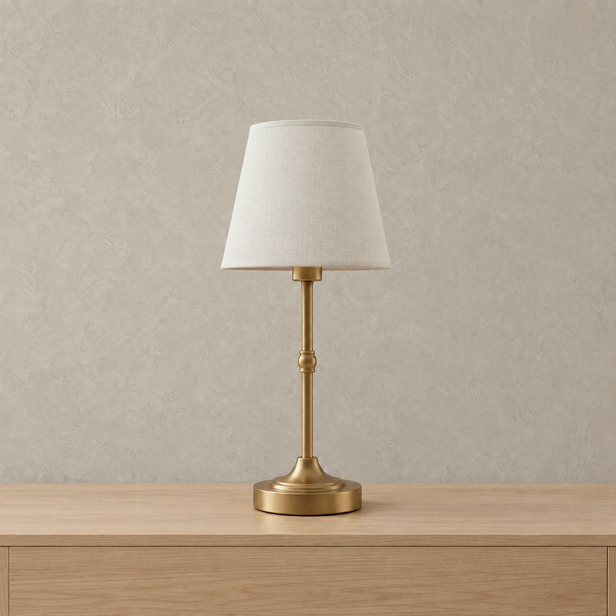 Sanovire gold and white rechargeable table lamp switched off on a plain backdrop