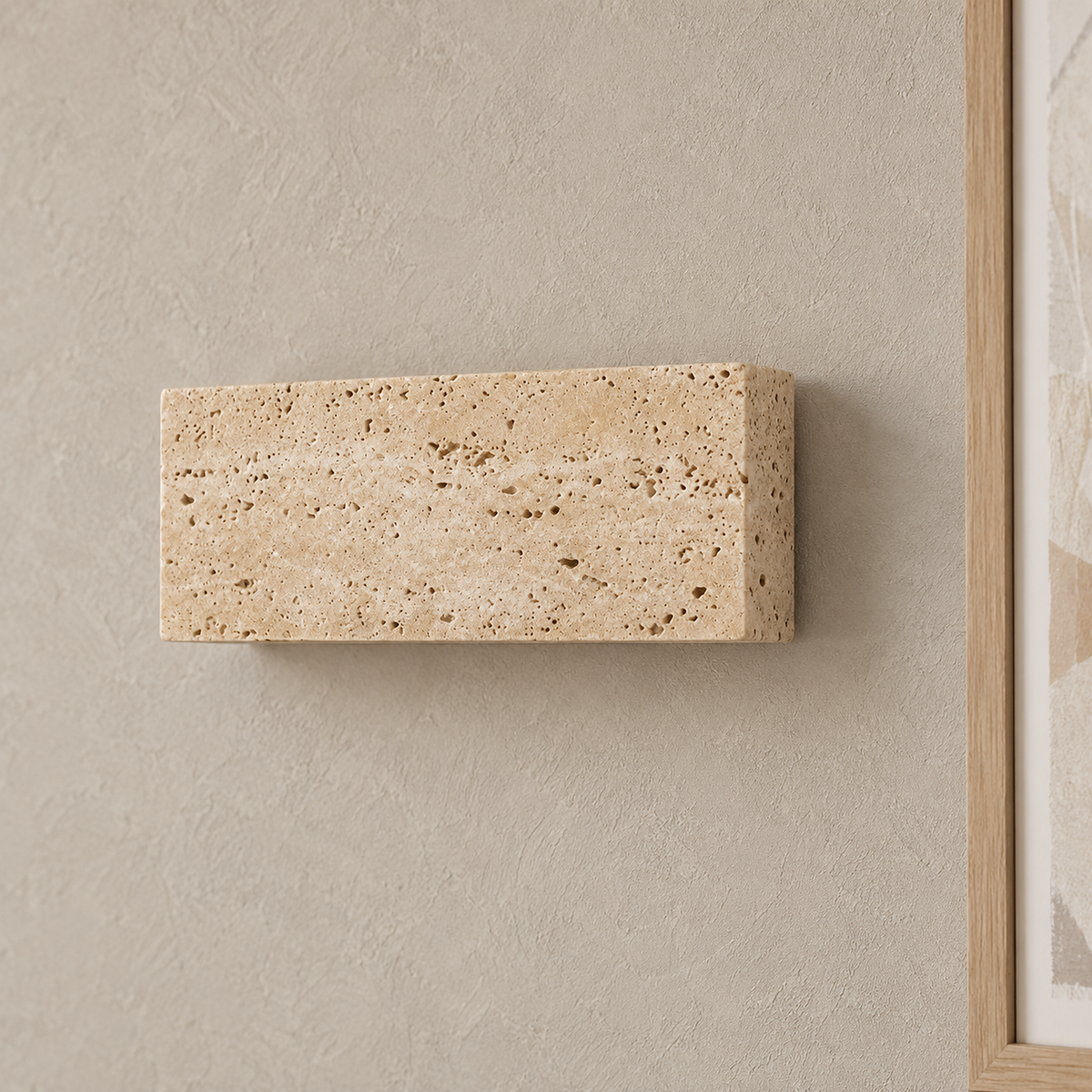Sarivol beige stone wall lamp up close, natural stone surface with darker pits in an entryway