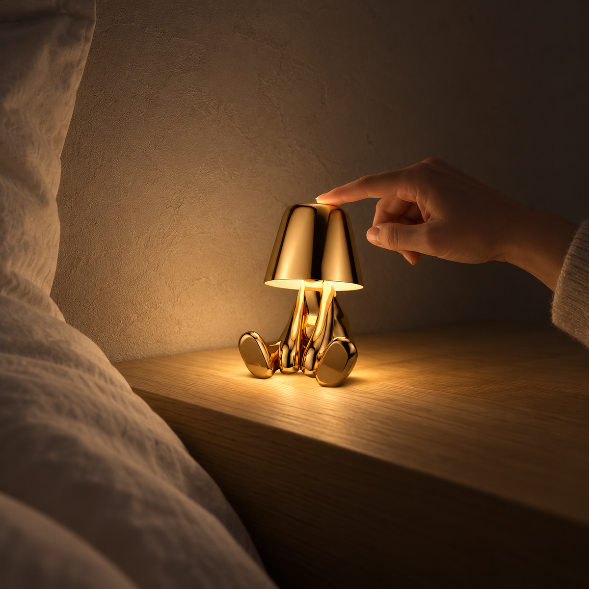 Sarovel gold battery operated table lamp giving a low glow at bedtime in a guest alcove