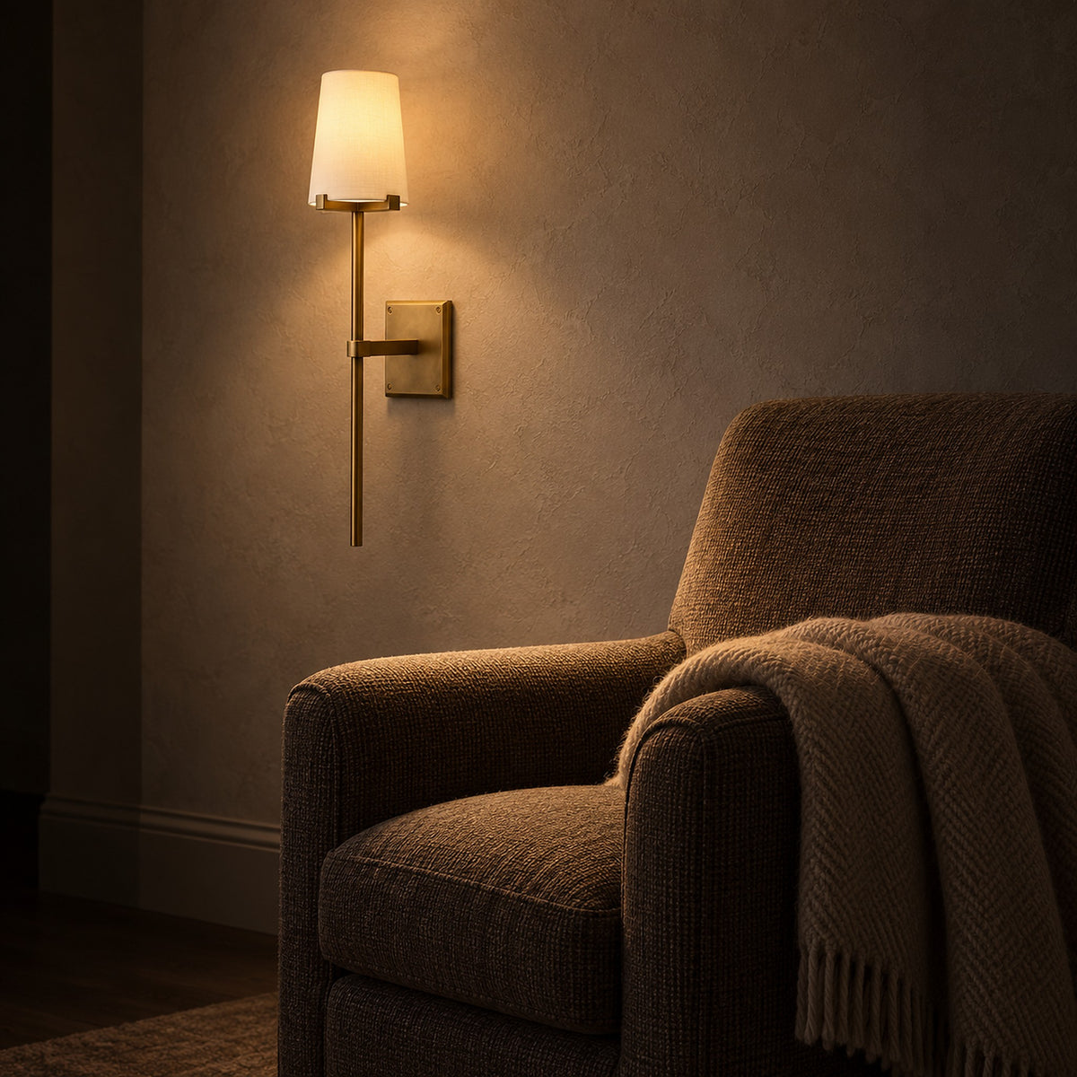 Savorel copper colored wall sconce with a fabric shade lighting library plaster at night