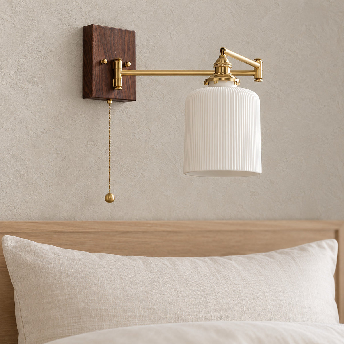 Selanvo gold and white wall lamp up close, showing the ceramic shade, gold colored arm and metal fittings