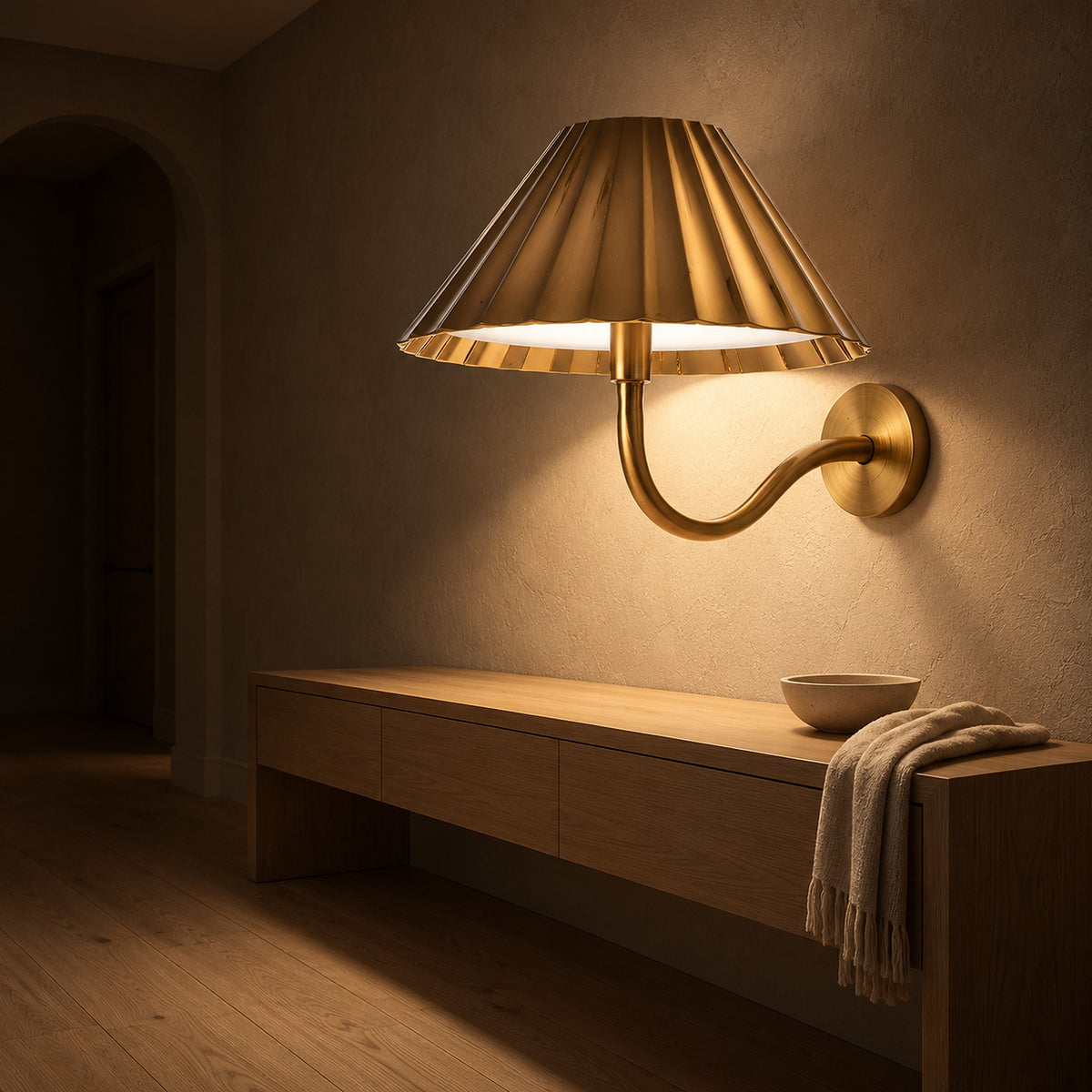 Selorna gold battery operated wall sconce glowing in an entryway at night