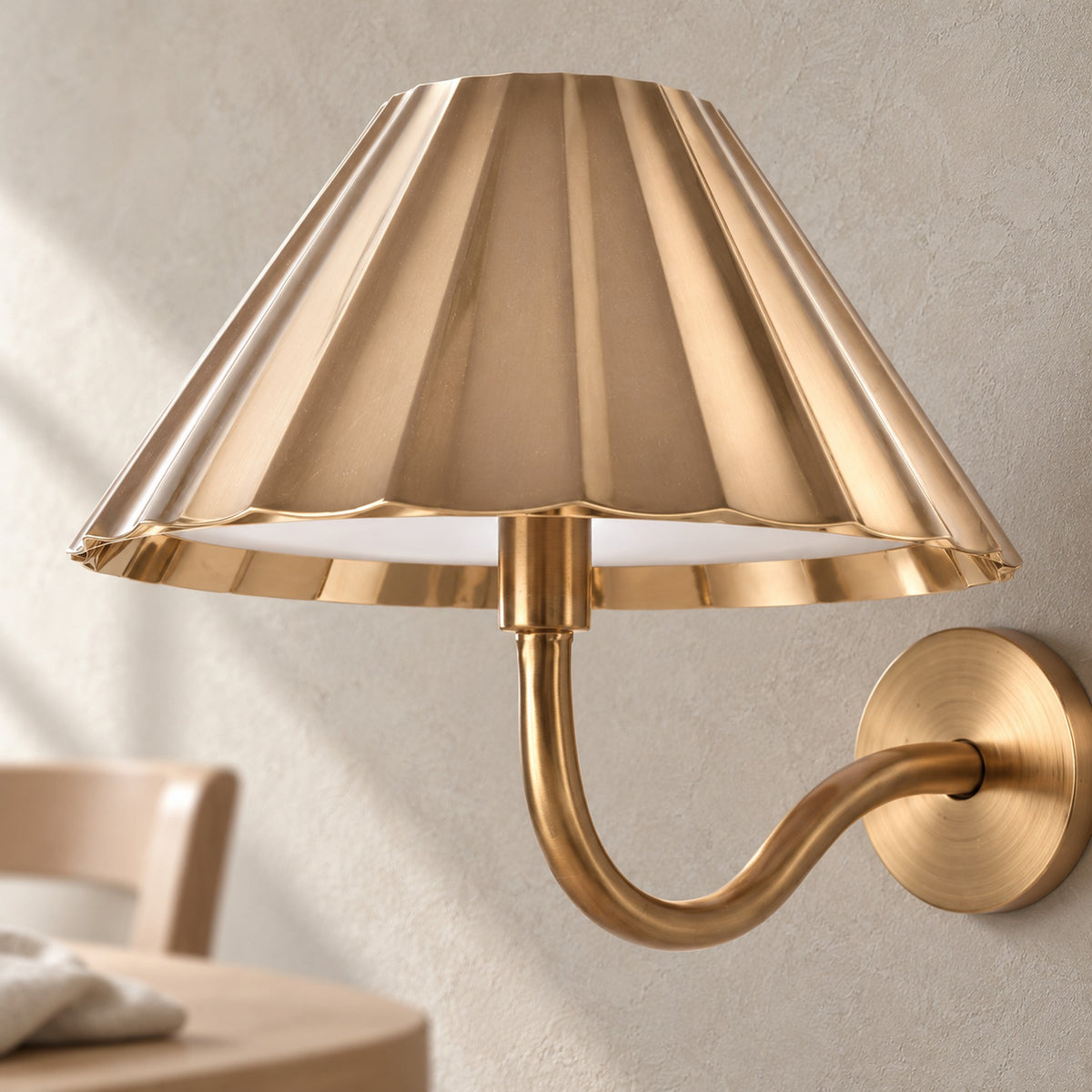 Selorna gold rechargeable wall sconce with a dome shade, a close detail in dining room daylight