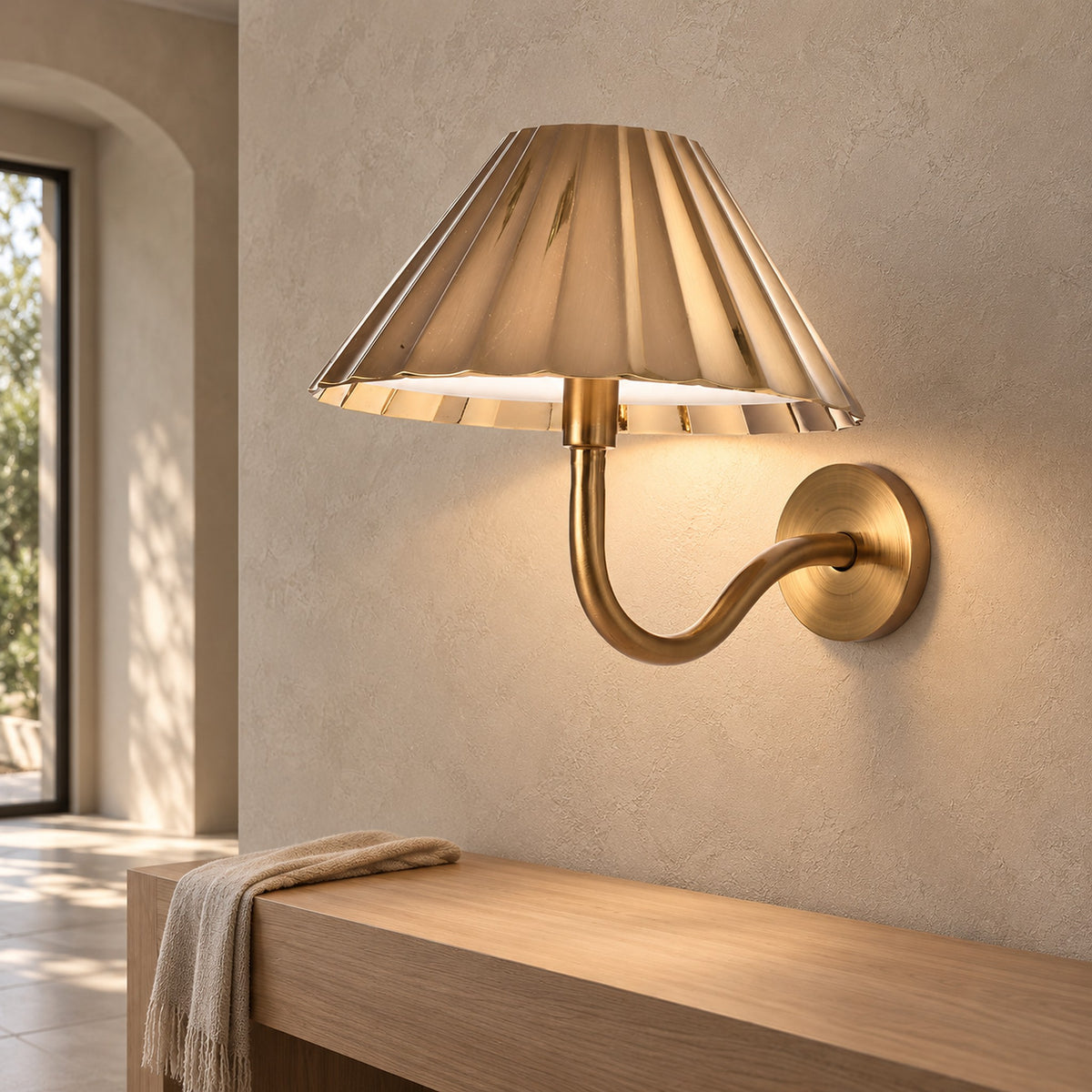 Selorna gold wall sconce arm and metal base seen up close in an entryway