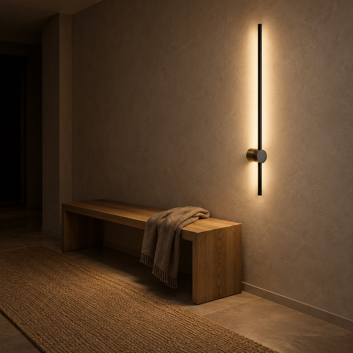 Semarlo black and gold hardwired wall light glowing in an entry vestibule after dark