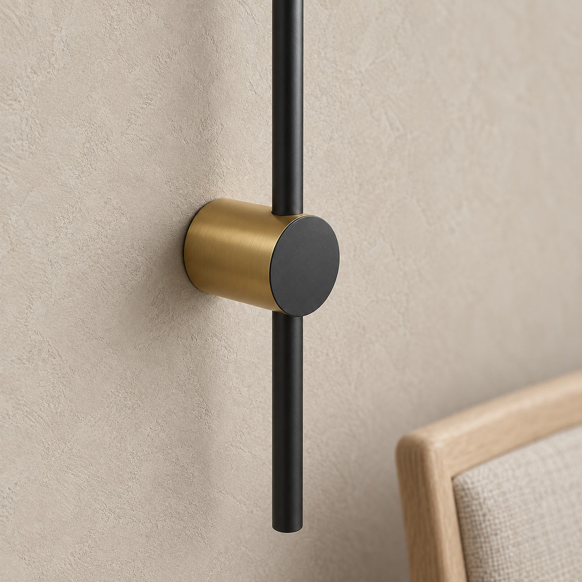 Semarlo black and gold wall lamp, close detail of the 6 cm circular base in a dining room