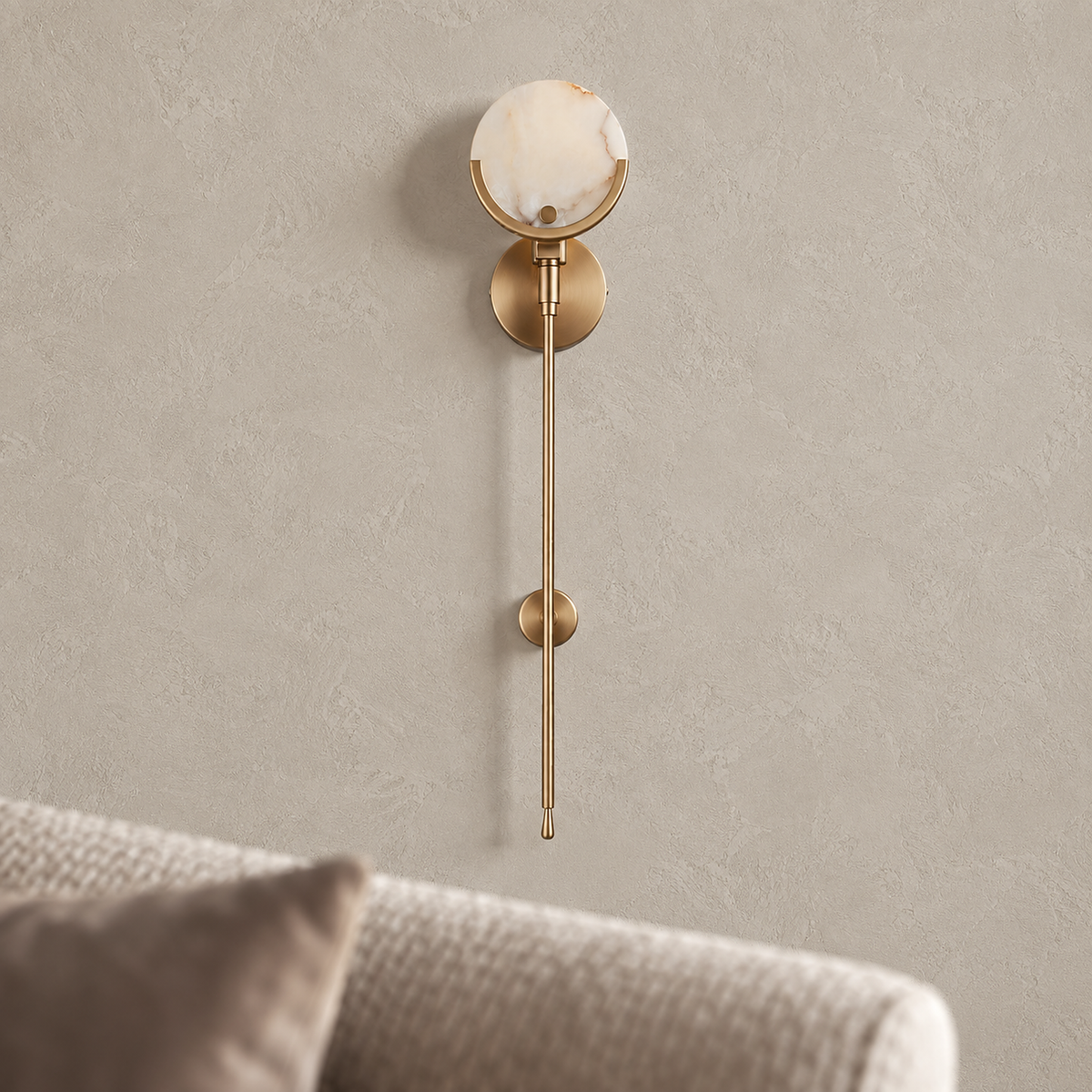 Serrinte brass wall sconce close up switched off, veined stone face and brass cradle on the stem