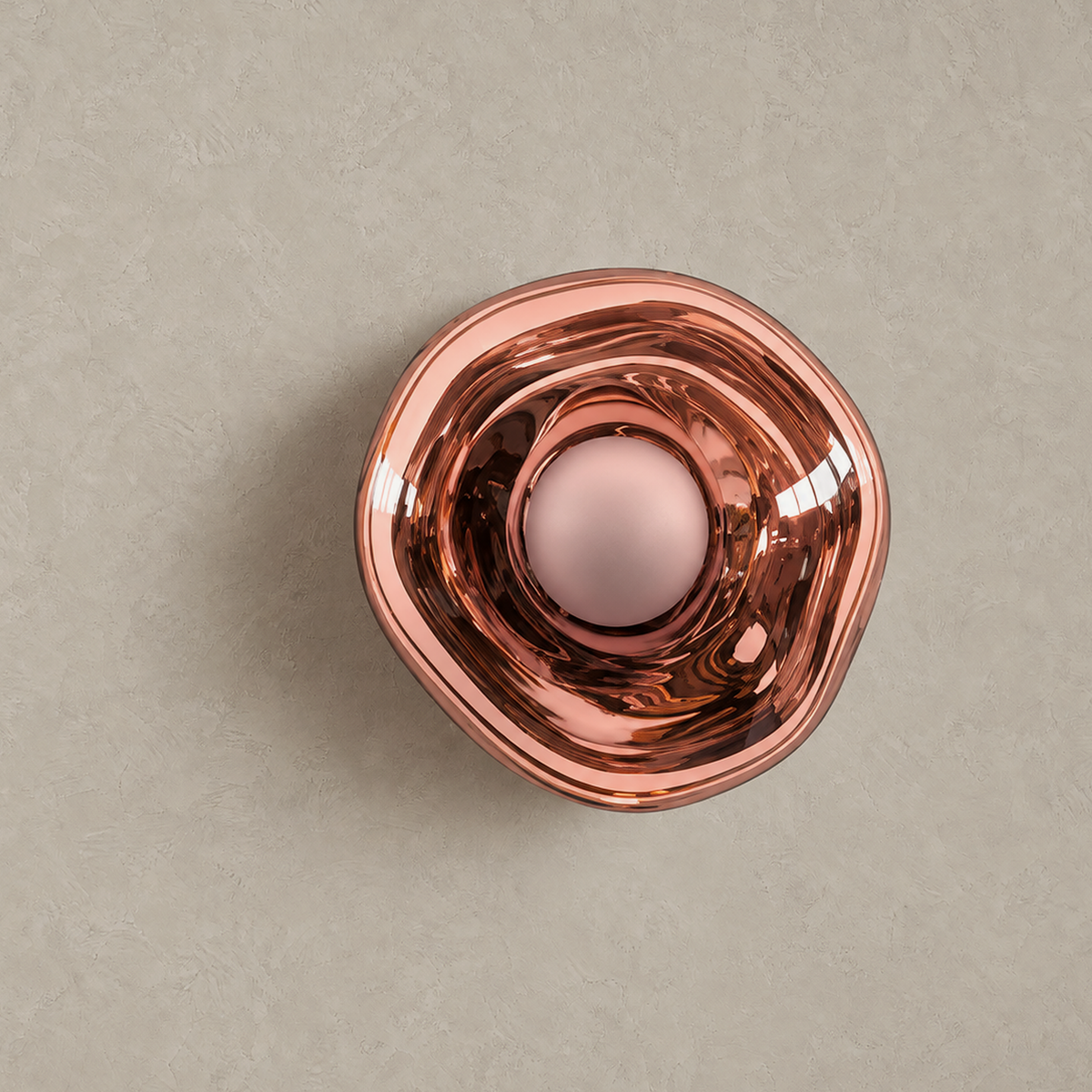 Sevalira rose gold wall sconce unlit on greige plaster with its rounded shade