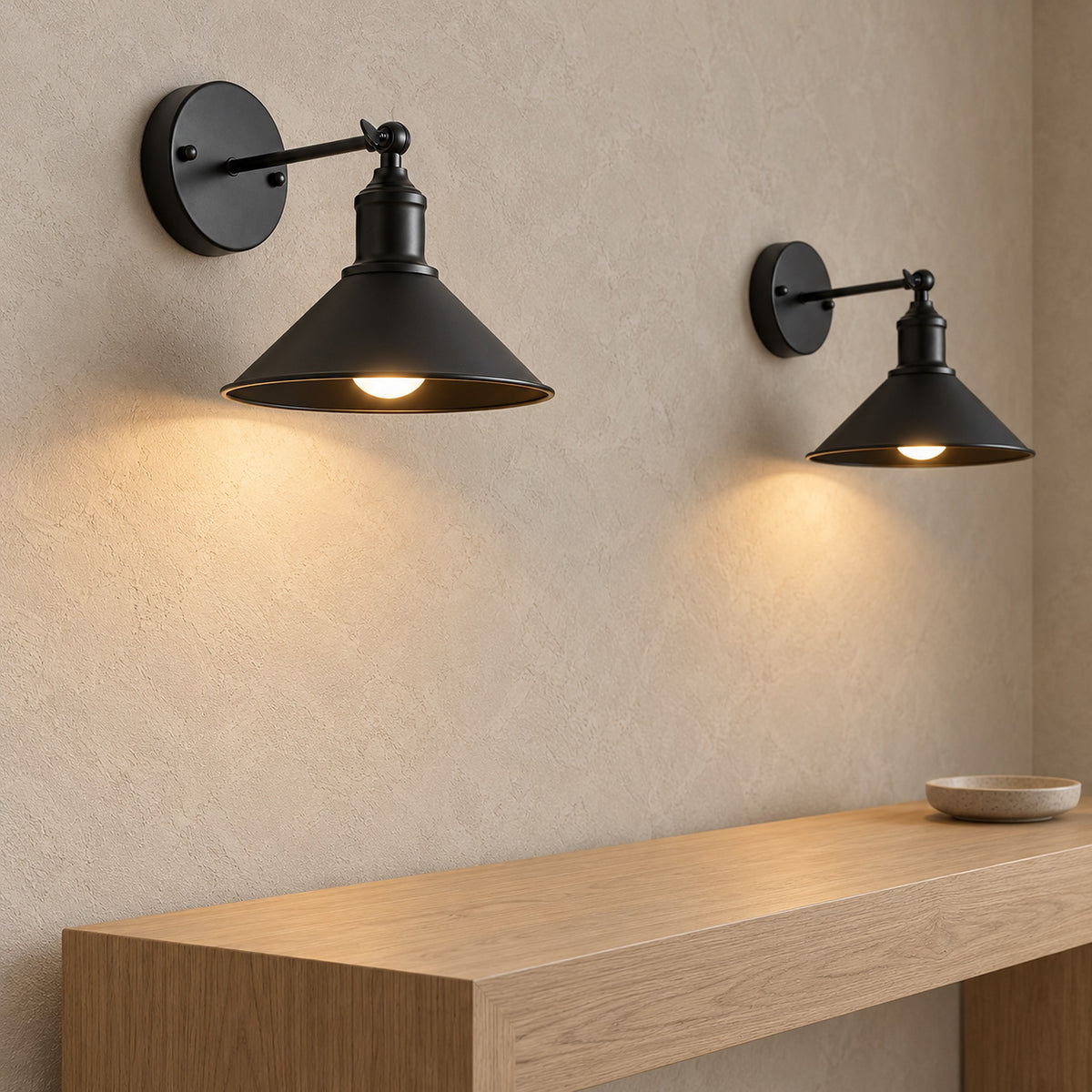 Sevarlo black wireless wall light pair lit above a clear entryway ledge in daylight