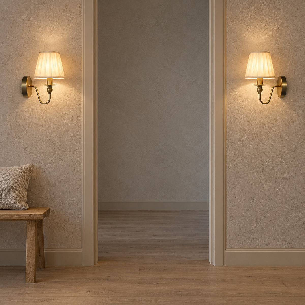 Siralto gold wall light pair lit on either side of a hallway doorway