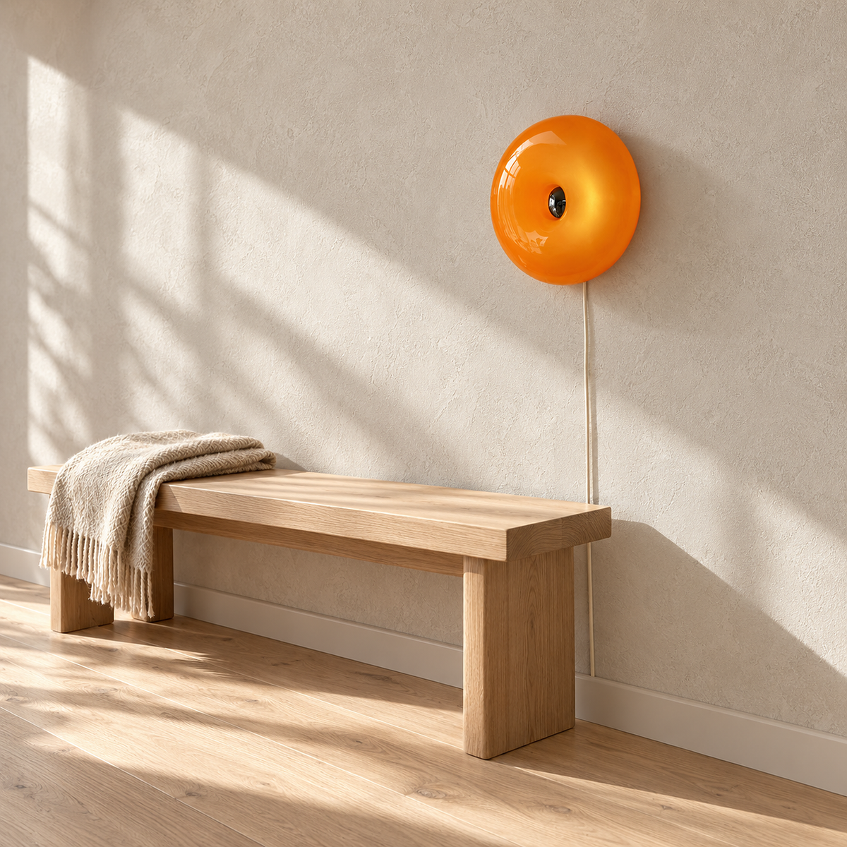 Siravel orange wall light shown unlit above a sunlit hallway bench