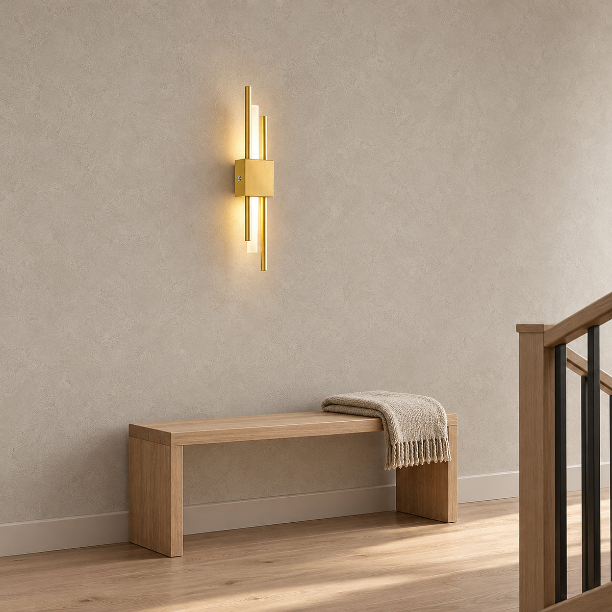 Sorlimo gold and white battery operated wall sconce lit on a stair landing wall by day