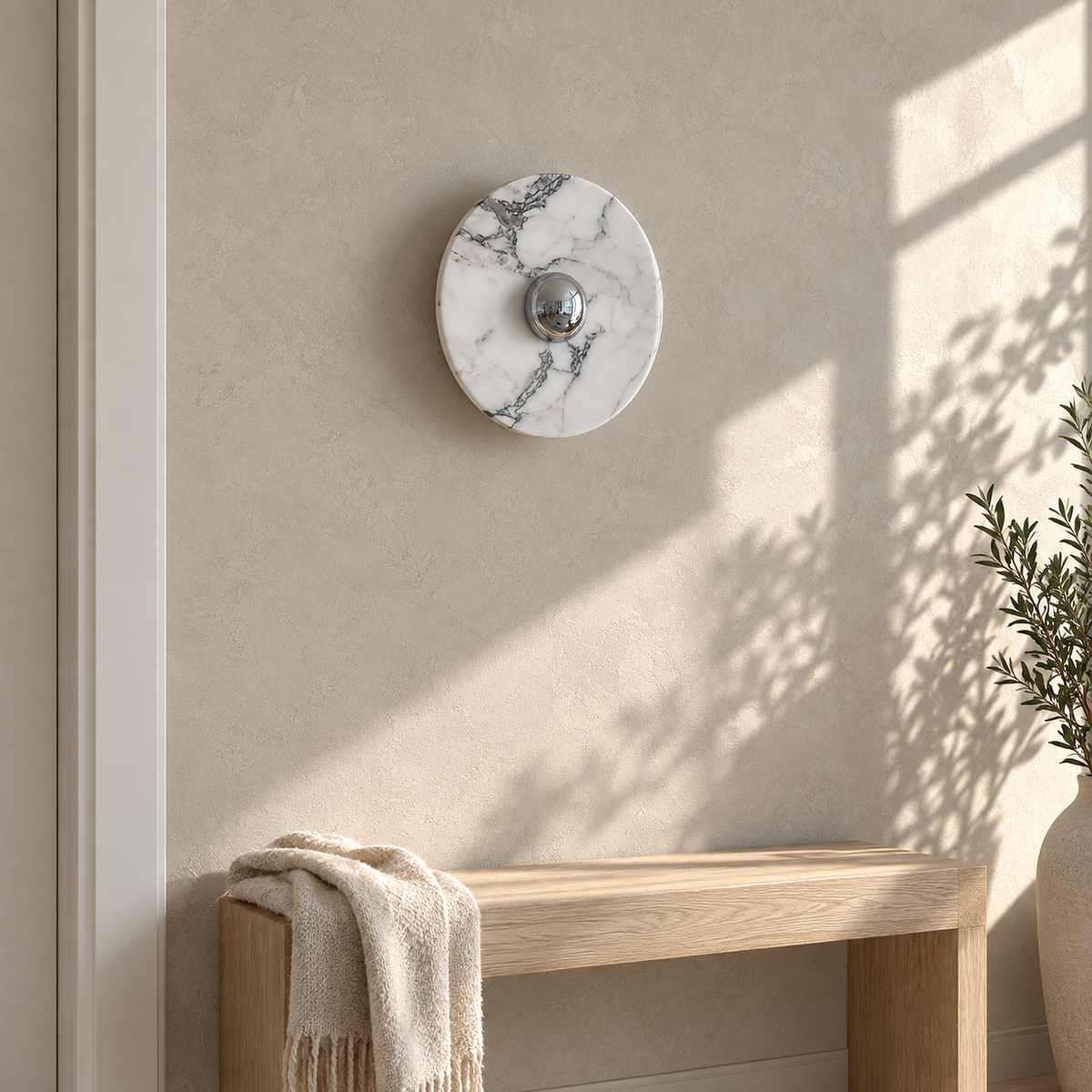 Talemio chrome marble wall sconce in the small size unlit on a sunlit entryway wall
