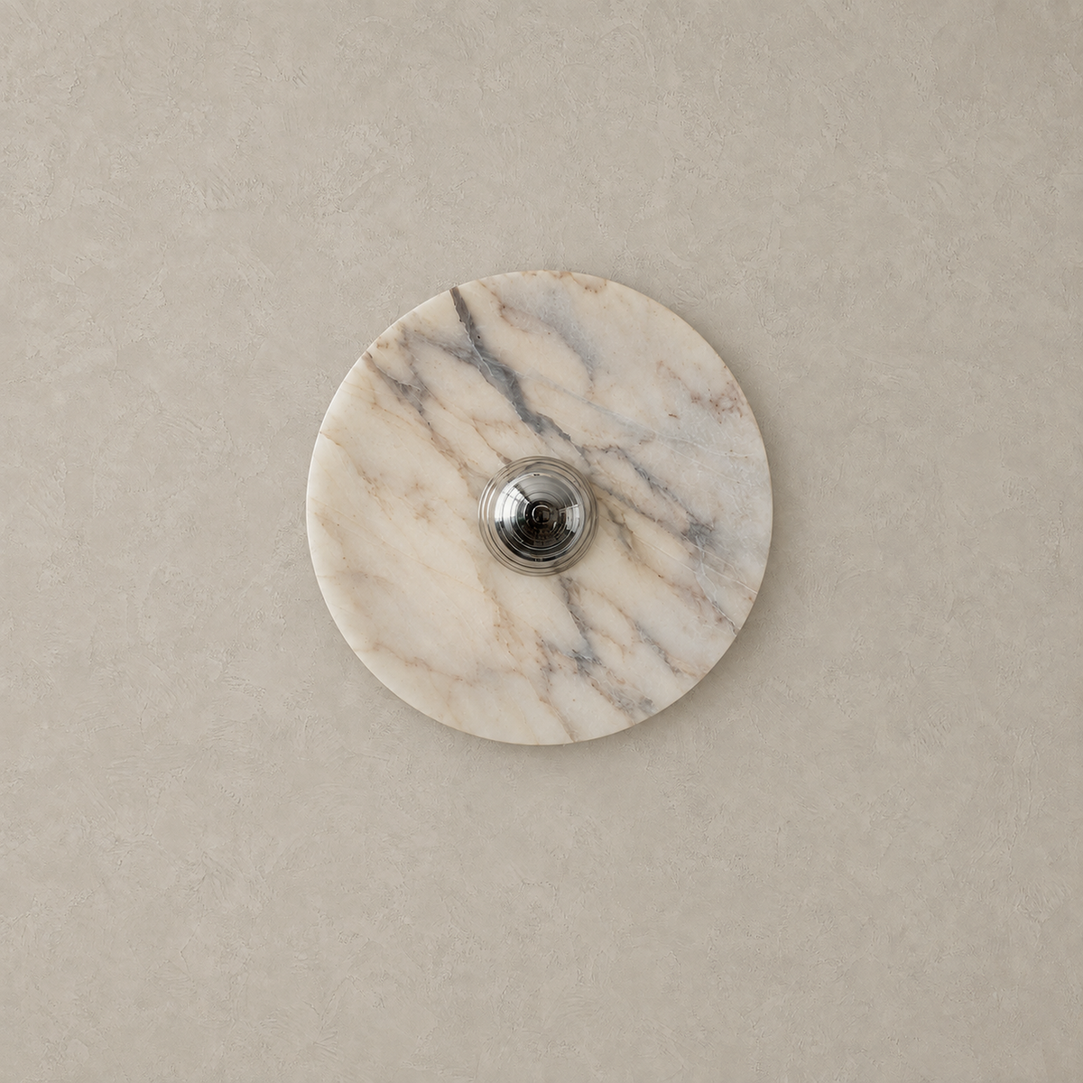 Talemio chrome marble wall sconce switched off against a greige plaster wall