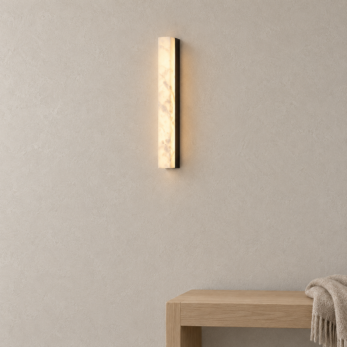 Talevira black wall sconce glowing warm white above an entryway bench in daylight