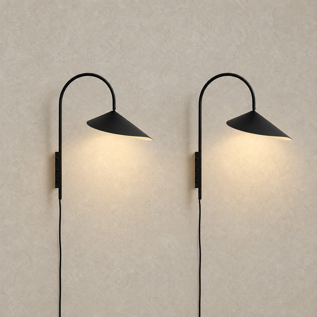 Talirsa black plug in wall sconce set of two, both lit and shown together