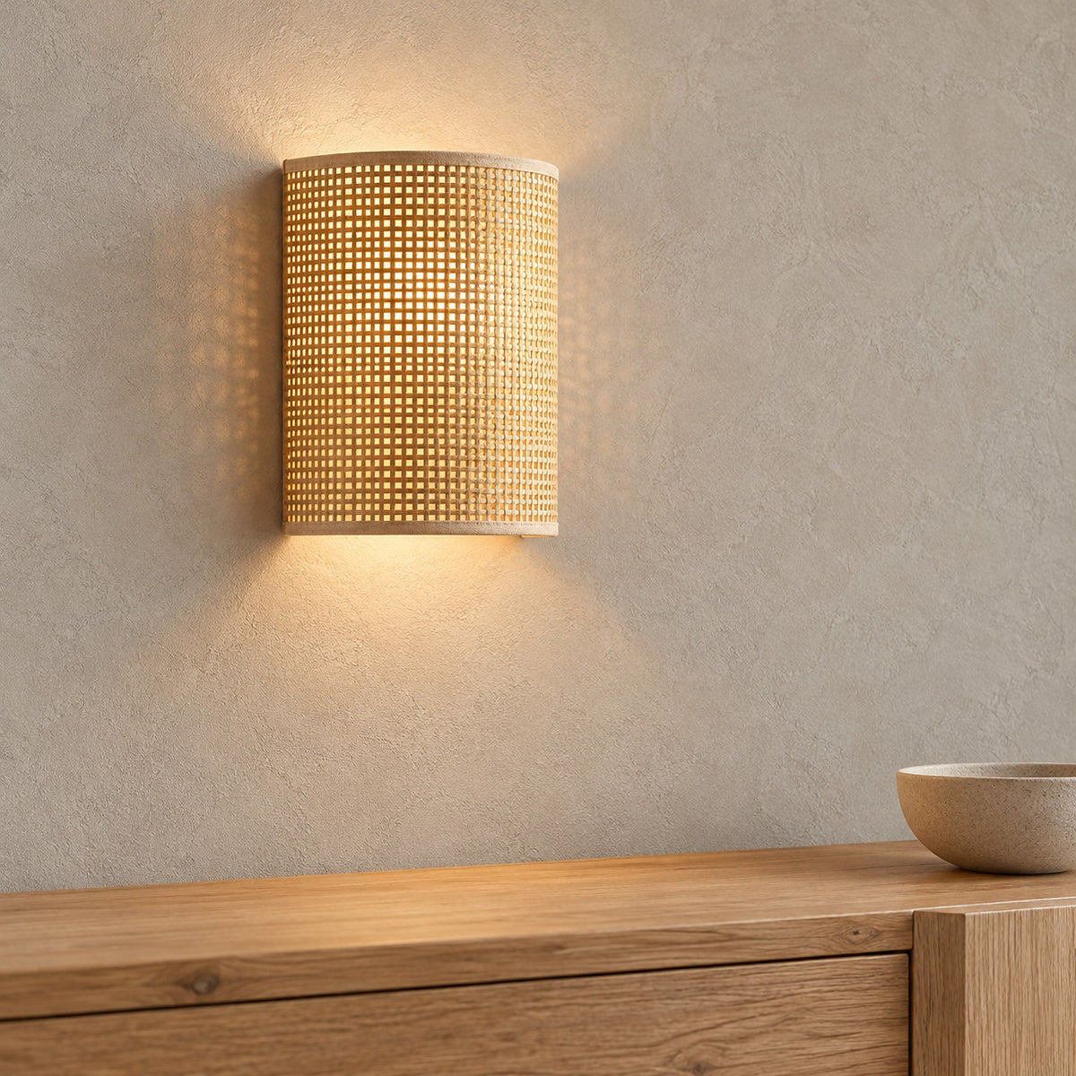 Talmevi light tan wall sconce casting a downward spill of light in a dining room