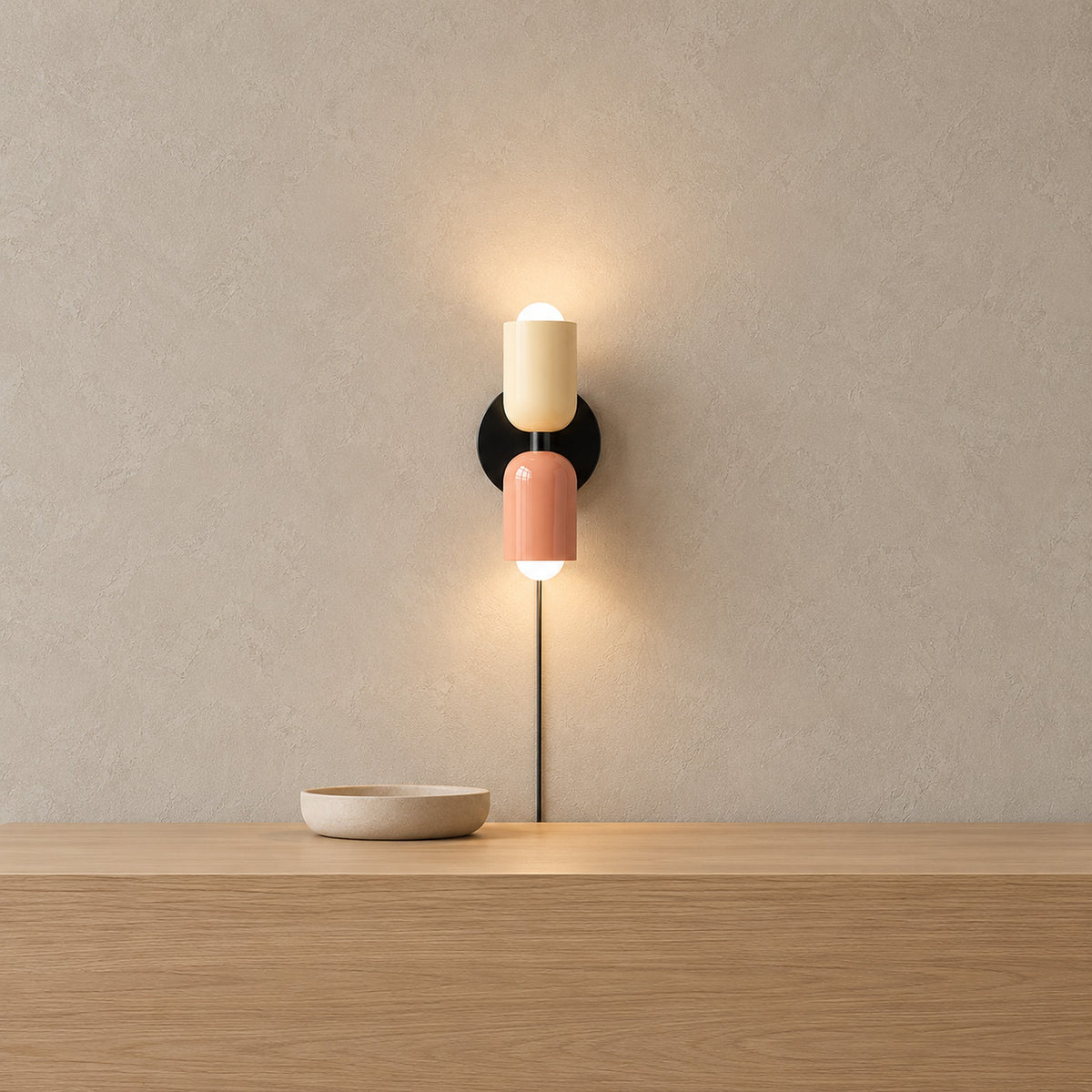 Talomi beige and pink plug in wall sconce lit above a pale entryway console with its cord visible #color_beige & pink