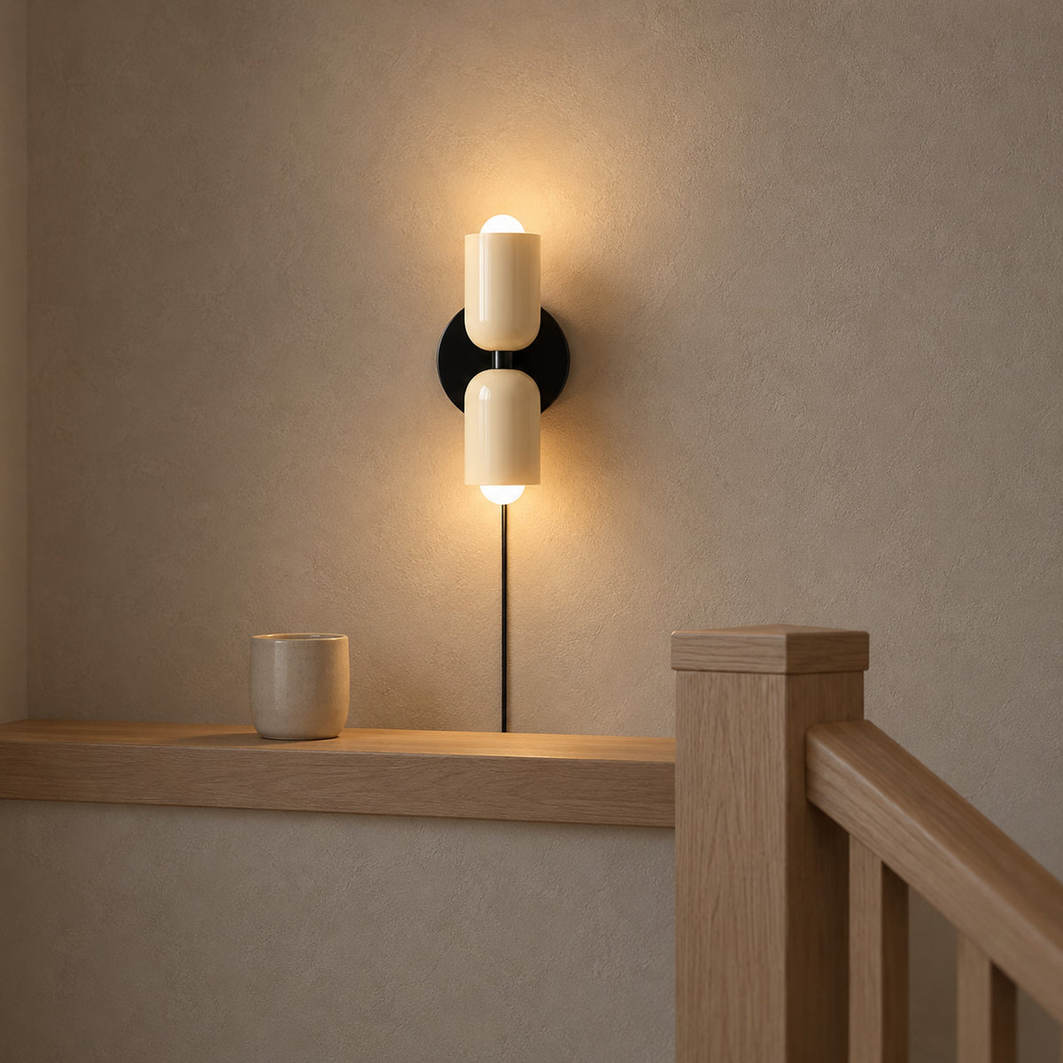 Talomi beige wall lamp glowing beside a stair landing ledge with light up and down