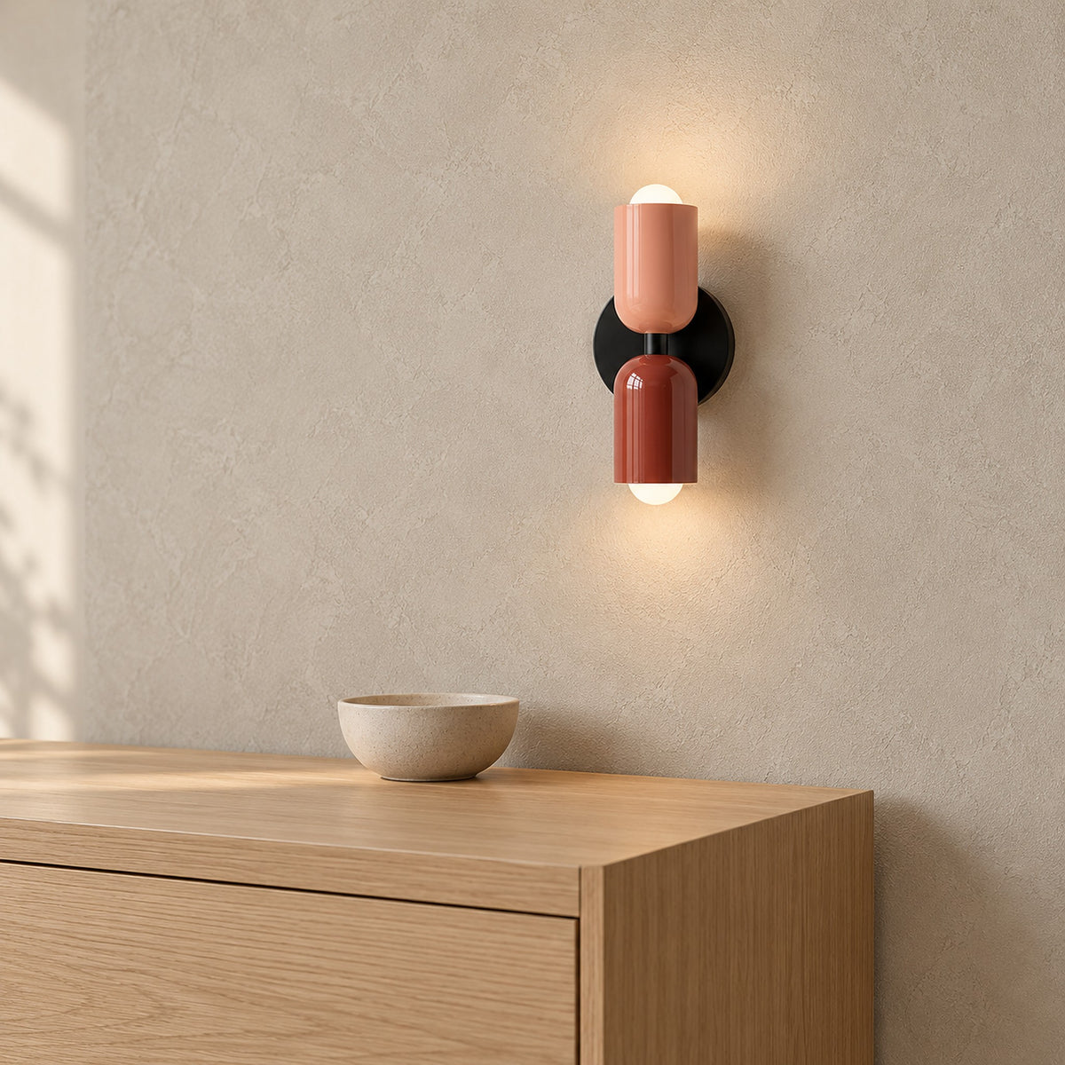 Talomi pink and red wall lamp glowing above the corner of a dining sideboard #color_pink & red