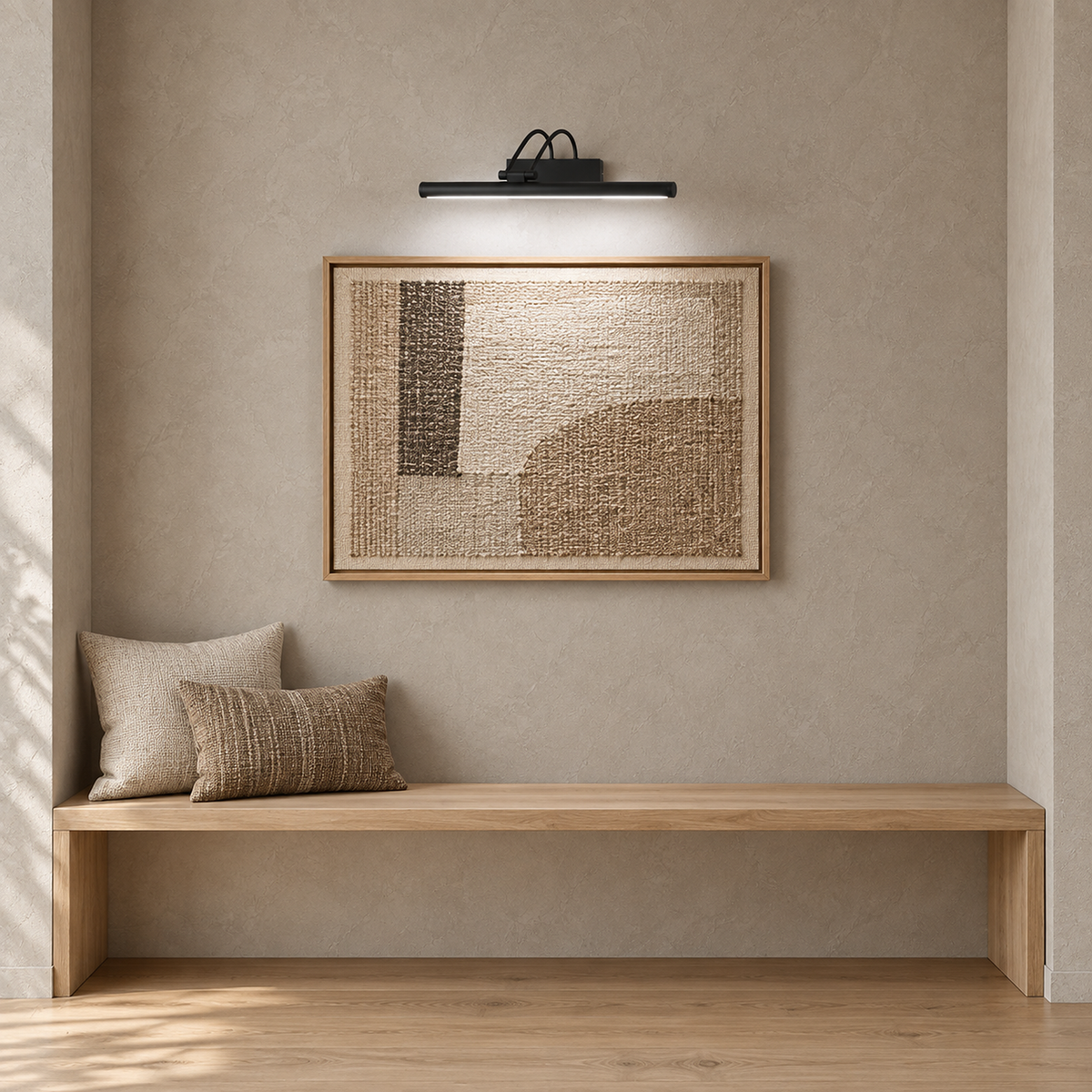 Tamirel black rechargeable wall sconce illuminating a framed textile above a bench in daylight