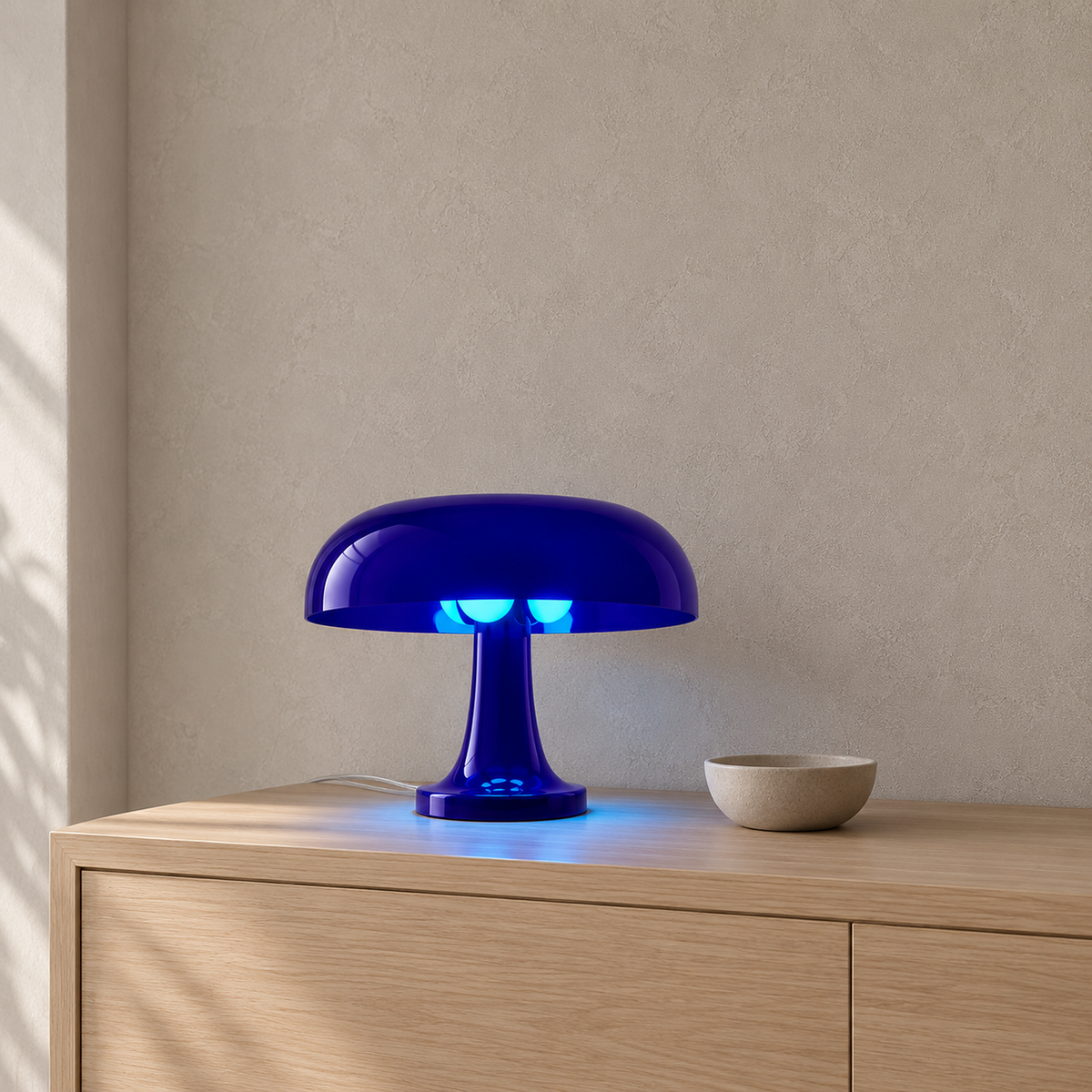 Tamolise blue table lamp glowing on an entryway console in daylight #color_blue