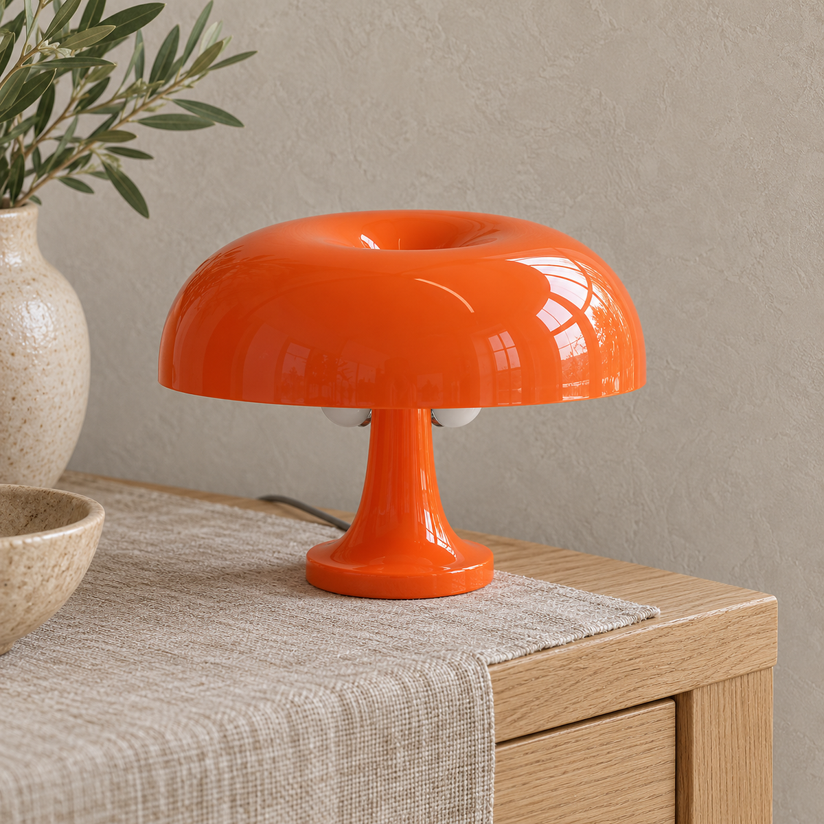 Tamolise orange table lamp close up on the glossy dome and recessed top