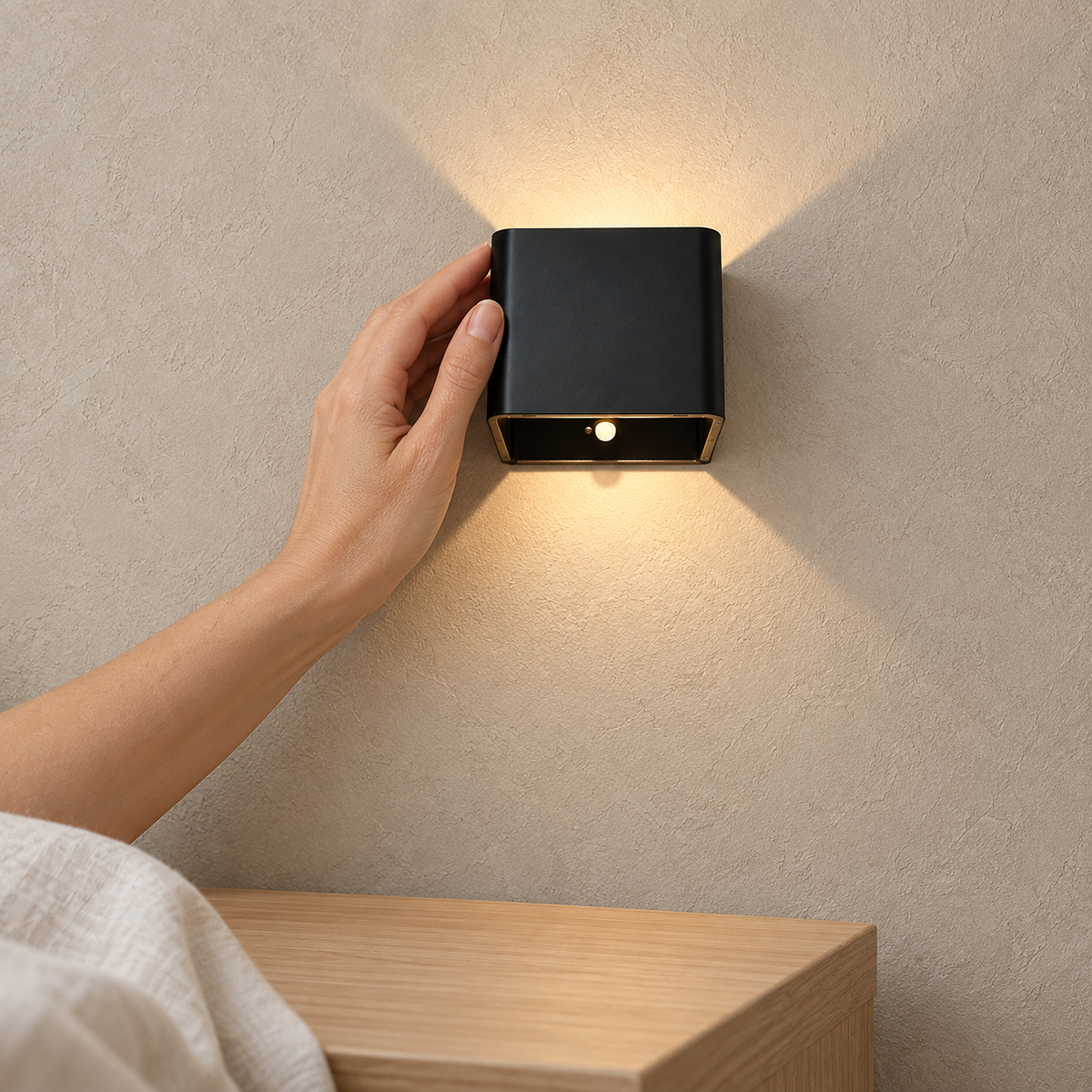 Tanelia black battery operated wall sconce leaving the bedside tabletop clear