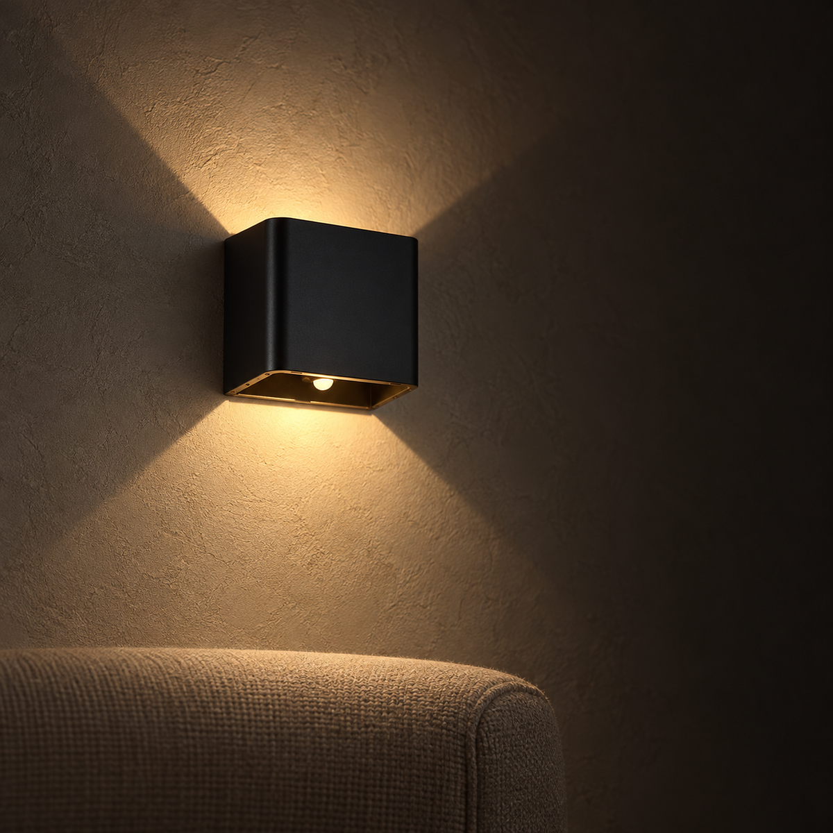 Tanelia black dimmable LED wall sconce casting a low warm evening wash in a reading snug