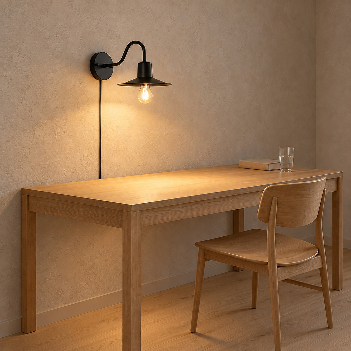 Tarelio black plug in wall light in a home office, gooseneck arm curving down to light the surface below