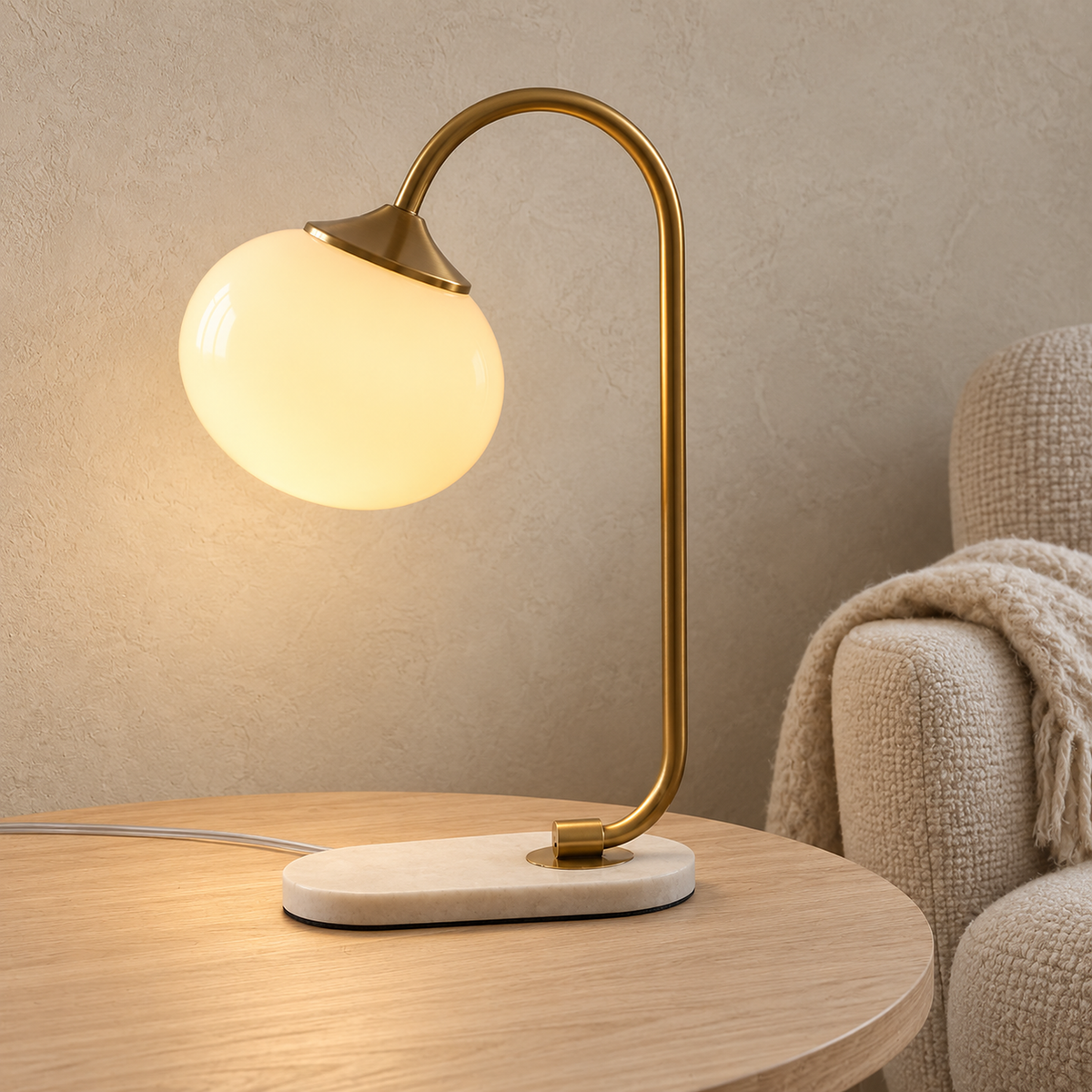 Taselvo gold and beige table lamp switched on beside a listening chair in a music room by day