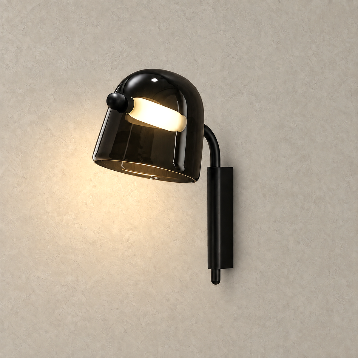 Tavessi black hardwired LED wall sconce glowing against plain plaster