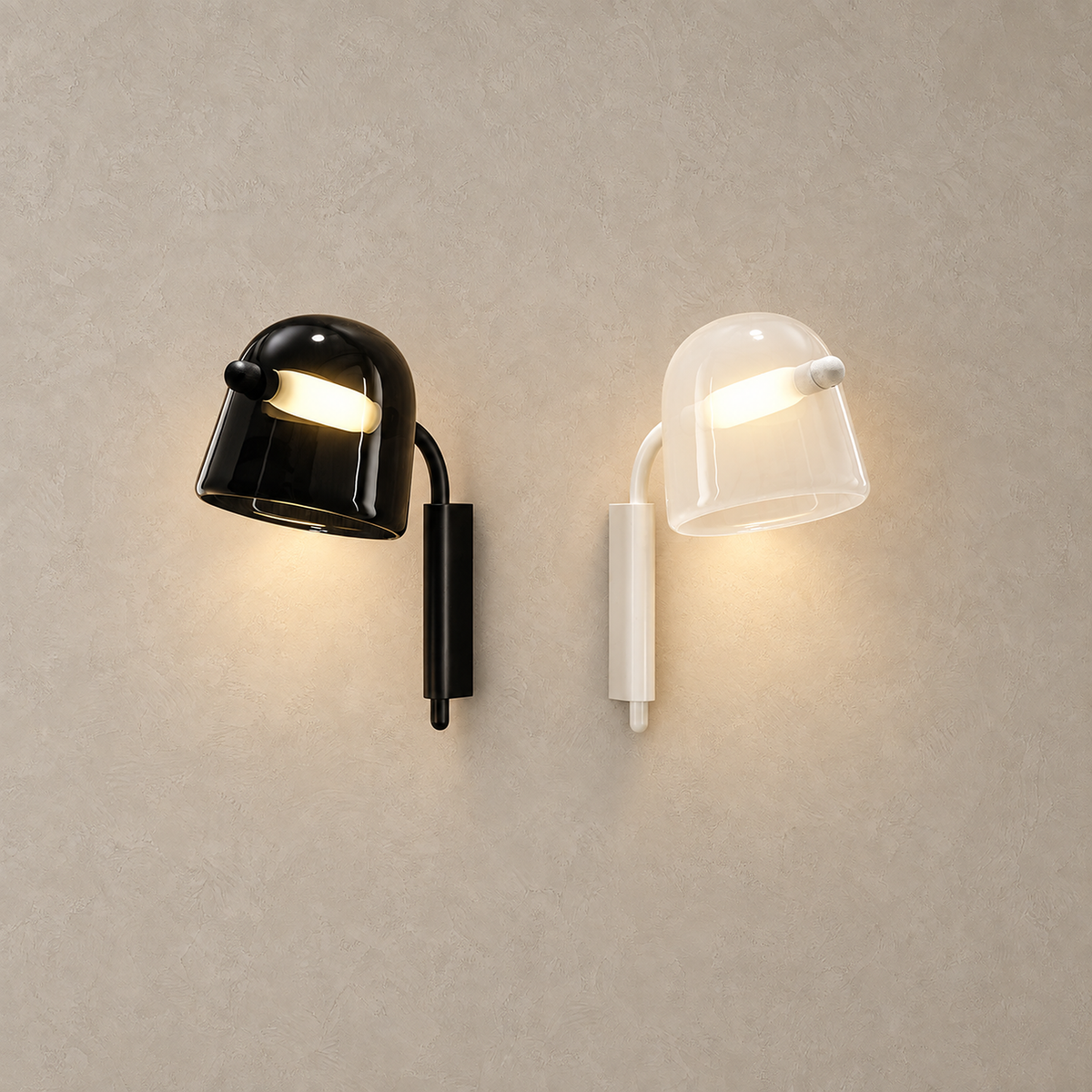 Tavessi glass wall sconces in black and white lit side by side on plain plaster
