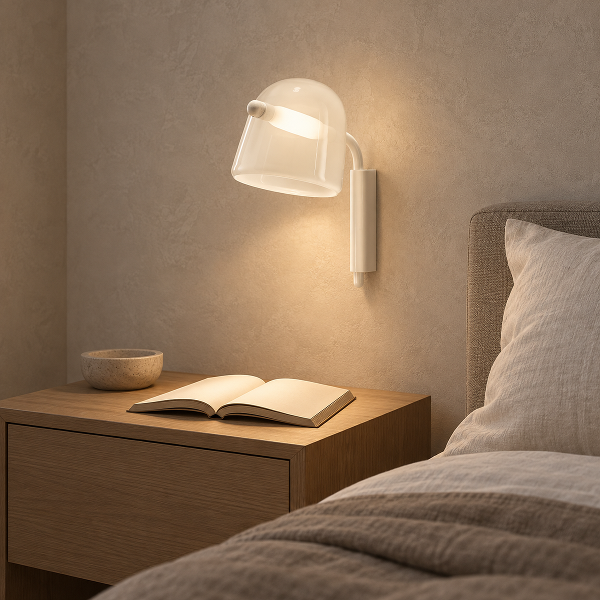 Tavessi white bedside lamp directing warm white light onto an open book #color_white